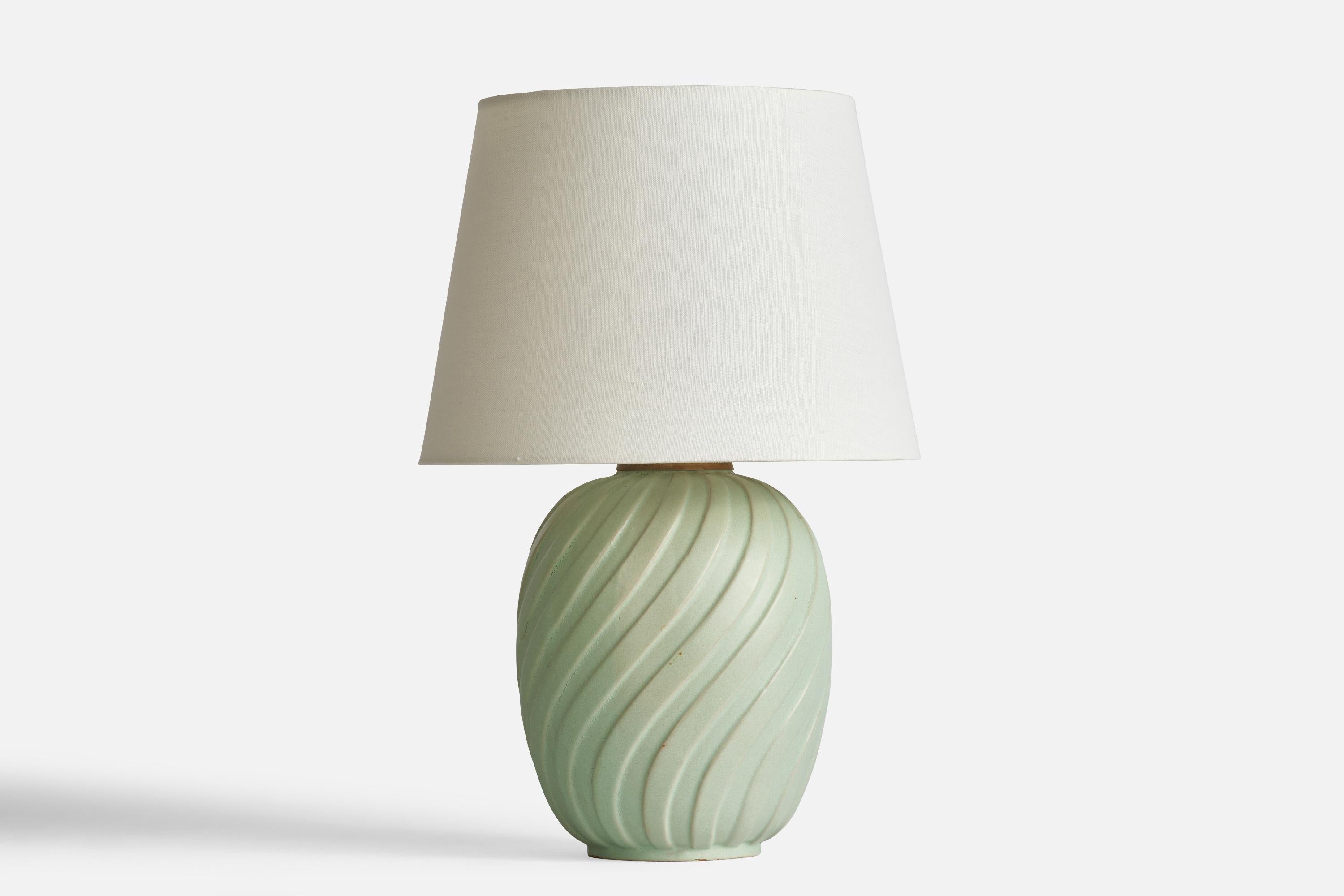 A celadon-green earthenware and brass table lamp designed and produced in Sweden, 1940s.

Dimensions of Lamp (inches): 12.5” H x 7.5” Diameter
Dimensions of Shade (inches): 9” Top Diameter x 12” Bottom Diameter x 9” H
Dimensions of Lamp with Shade