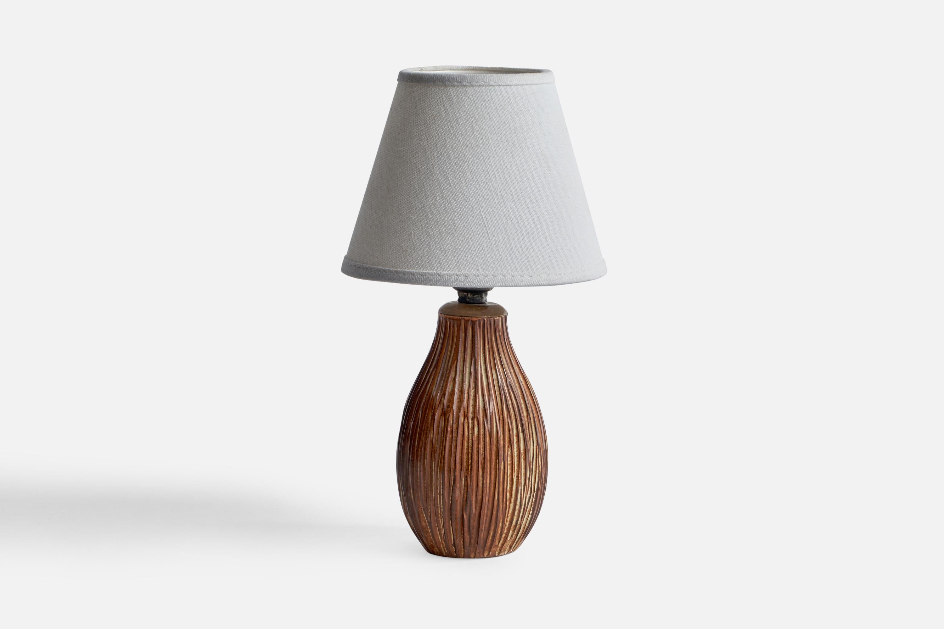 A brown-glazed incised earthenware table lamp designed and produced in Sweden, 1950s.

Dimensions of Lamp (inches): 7.8” H x 3.3” Diameter
Dimensions of Shade (inches): 3” Top Diameter x 5.75” Bottom Diameter x 4.5” H
Dimensions of Lamp with Shade