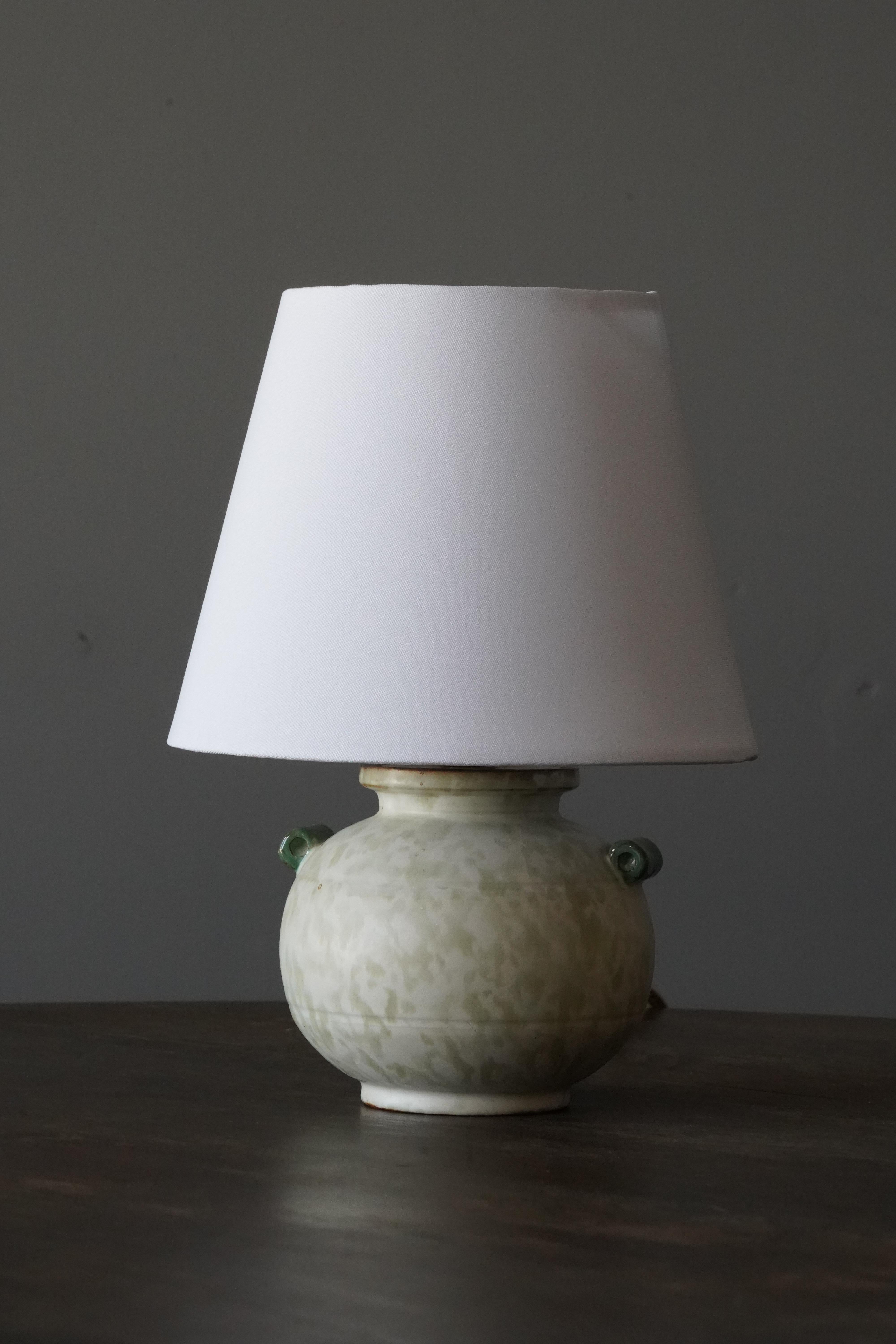 An early modernist table lamp. by Upsala-Ekeby, Sweden, 1930s. Stamped. Incised decor. 

Stated dimensions exclude lampshade. Height includes the socket. Sold without lampshade.

Other designers of the period include Ettore Sottsass, Carl Harry