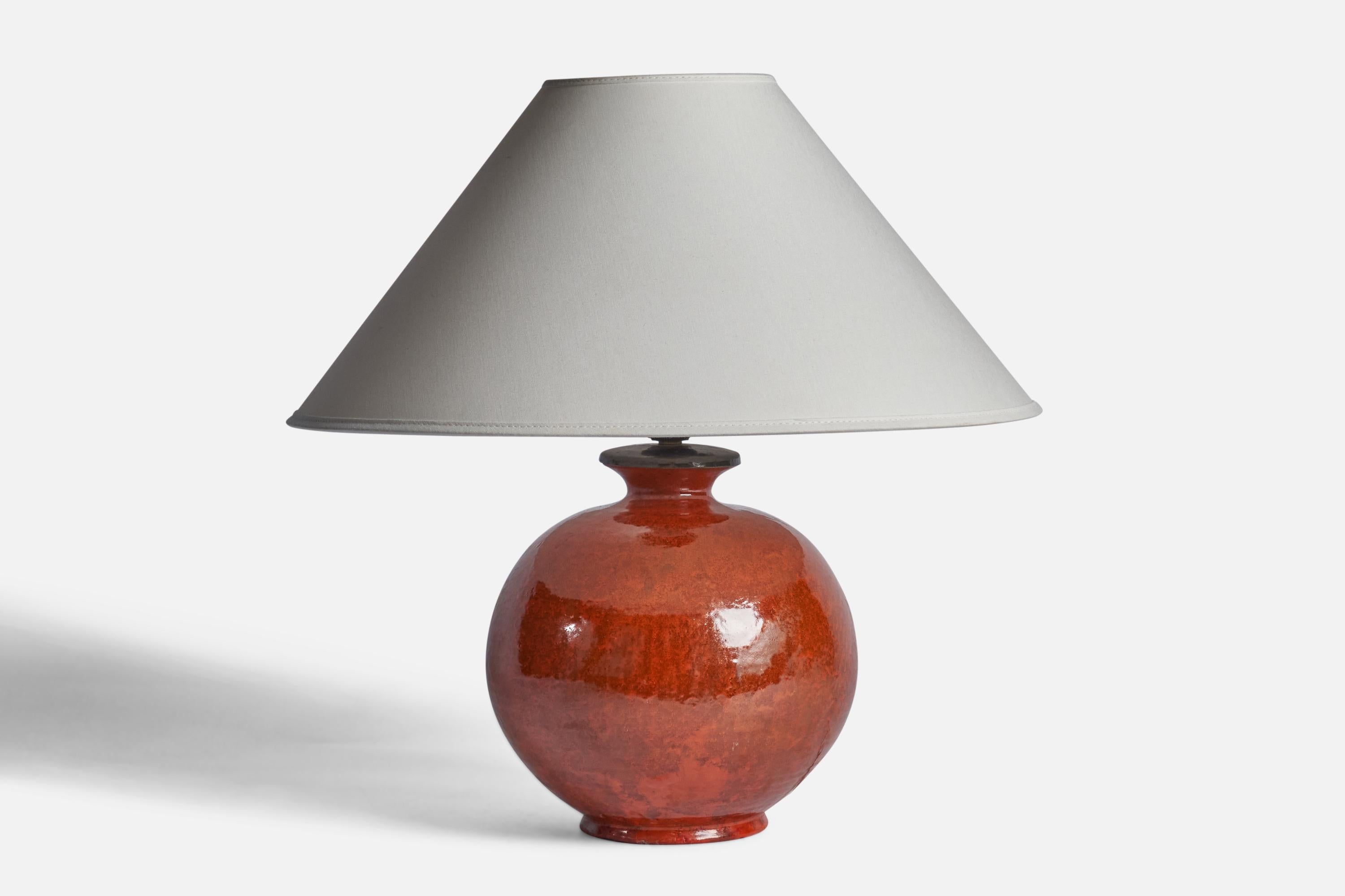 An red-glazed earthenware table lamp designed and produced by Upsala Ekeby, 1930s. 

Dimensions of Lamp (inches): 11.5” H x 8” Diameter
Dimensions of Shade (inches): 4.5” Top Diameter x 16” Bottom Diameter x 9” H 
Dimensions of Lamp with Shade