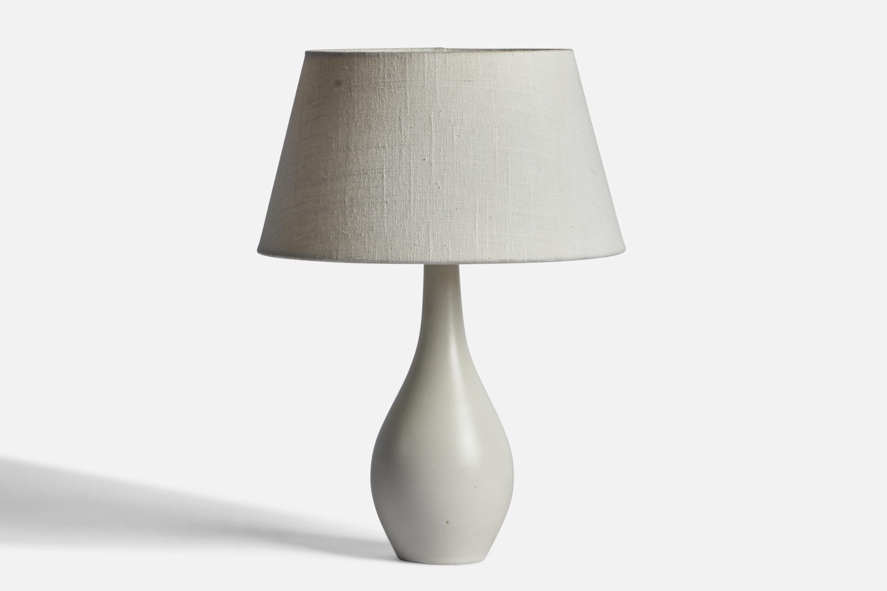An off-white-glazed earthenware table lamp designed and produced in Sweden, 1940s.

Dimensions of Lamp (inches): 11” H x 3.95” Diameter
Dimensions of Shade (inches): 7” Top Diameter x 10” Bottom Diameter x 5.5” H 
Dimensions of Lamp with Shade