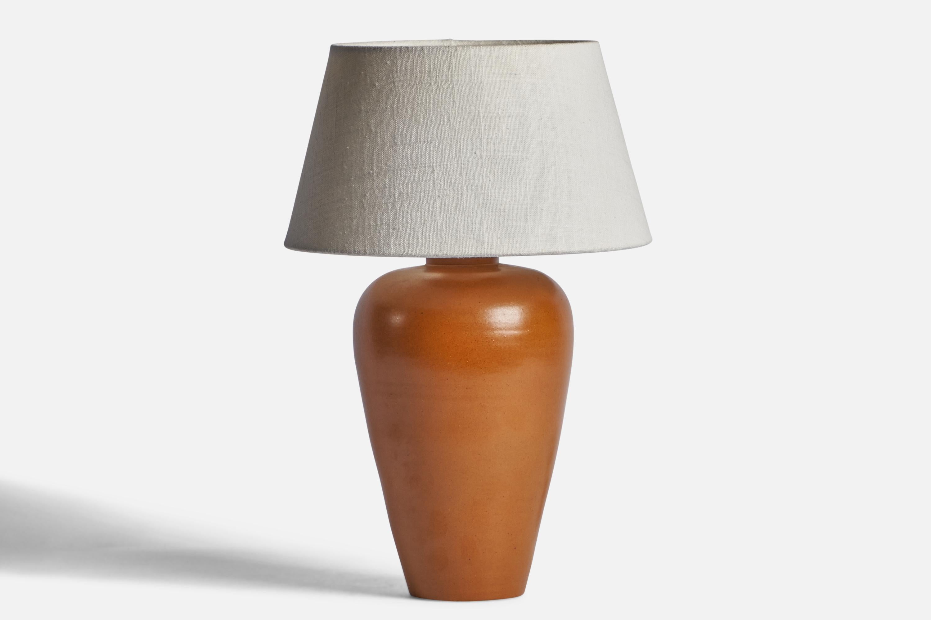 A brown-glazed earthenware table lamp produced by Upsala Ekeby, Sweden, c. 1950s.

Dimensions of Lamp (inches): 12” H x 6” Diameter
Dimensions of Shade (inches): 7” Top Diameter x 10” Bottom Diameter x 5.5” H 
Dimensions of Lamp with Shade (inches):