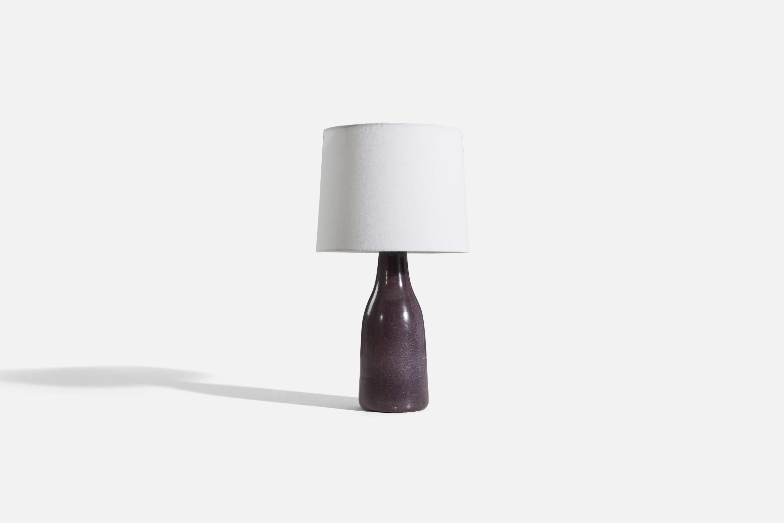 A purple-glazed earthenware table lamp designed and produced by Upsala-Ekeby, Sweden, 1930s.

Sold without lampshade. 
Dimensions of Lamp (inches) : 14.5 x 4.5 x 4.5 (H x W x D)
Dimensions of Shade (inches) : 9 x 10 x 8 (T x B x H)
Dimension of