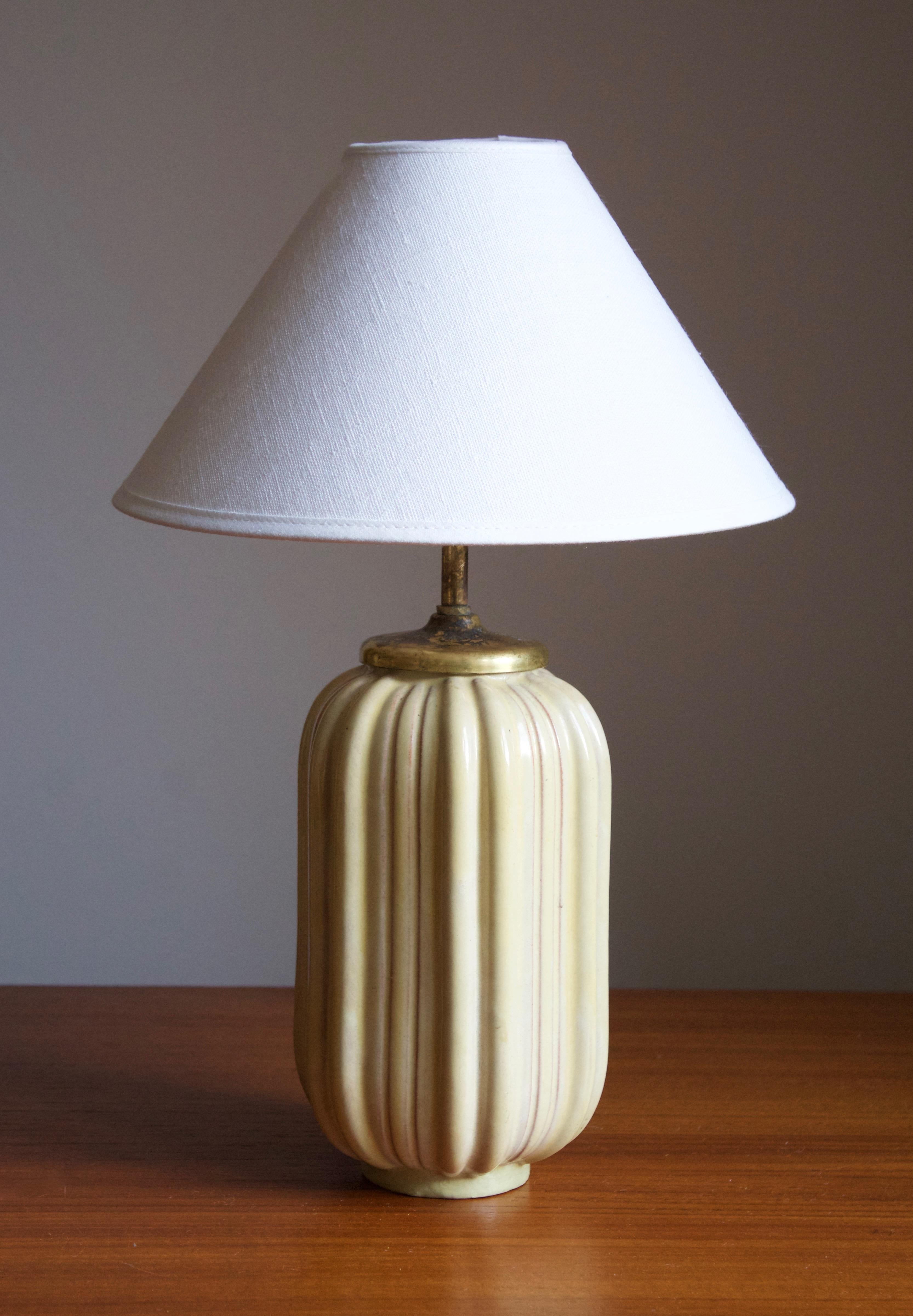 An early modernist table lamp. Produced by Upsala-Ekeby, Sweden, 1930s.

Stated dimensions exclude lampshade. Height includes socket. Sold without lampshade.

Glaze features a yellow color.

Other designers of the period include Ettore Sottsass,