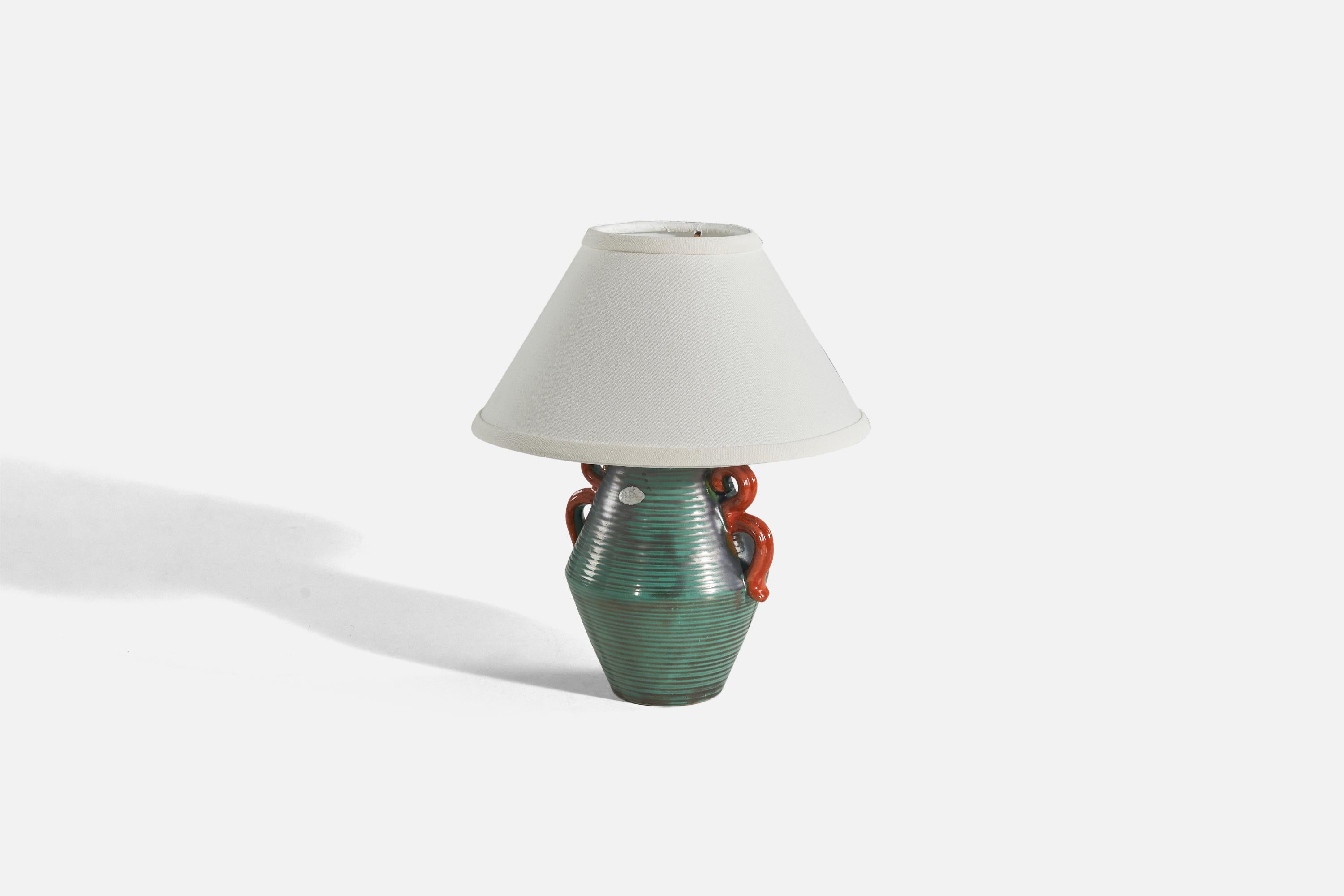 A green and red, glazed earthenware and brass table lamp designed and produced by Upsala-Ekeby, Sweden, 1940s.

Sold without lampshade. 
Dimensions of Lamp (inches) : 9.56 x 6.5 x 5.37 (height x width x depth)
Dimensions of Shade (inches) : 4.25