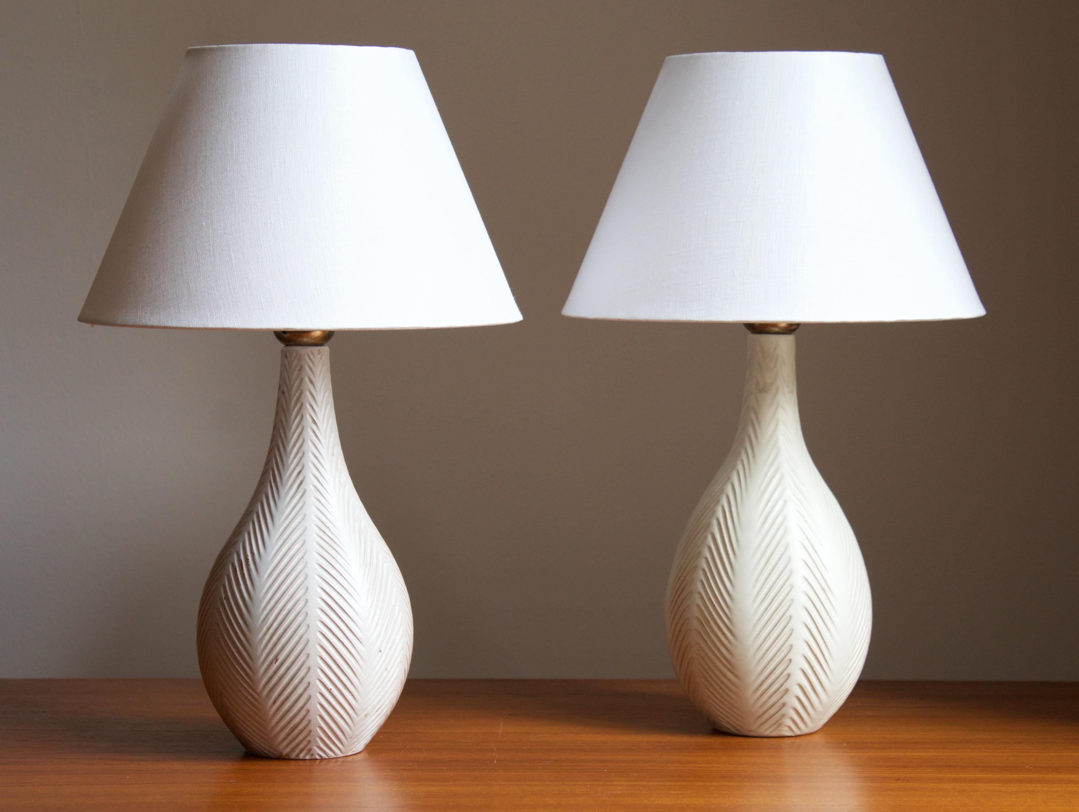 A pair of early modernist table lamps. Produced by Upsala-Ekeby, Sweden, 1930s.

Stated dimensions exclude lampshades. Height includes the socket. Sold without lampshades.

Other designers of the period include Ettore Sottsass, Carl Harry Stålhane,