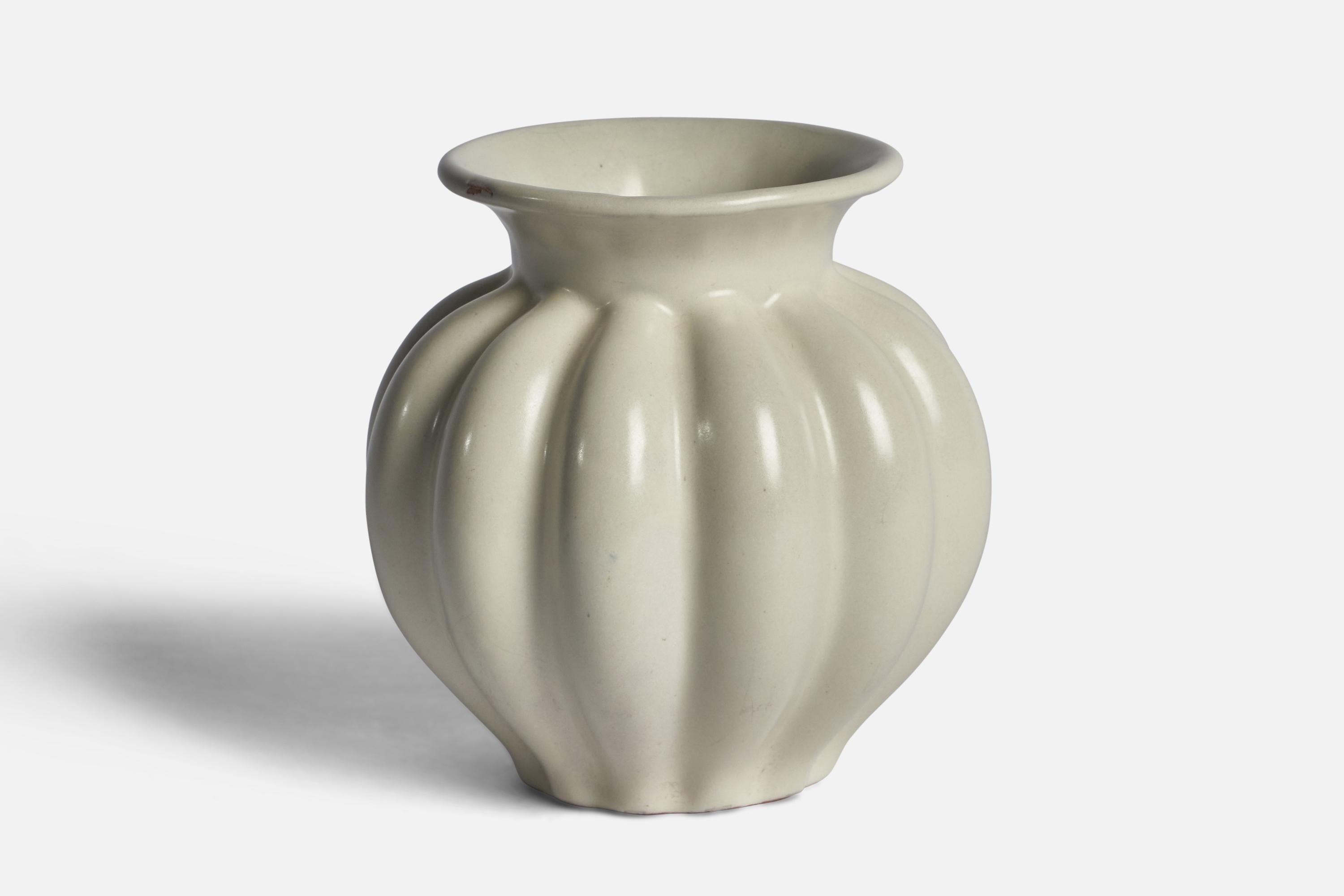 An off-white glazed earthenware vase designed and produced by Upsala Ekeby, Sweden, 1930s.

Production-related absence of glaze to upper rim.