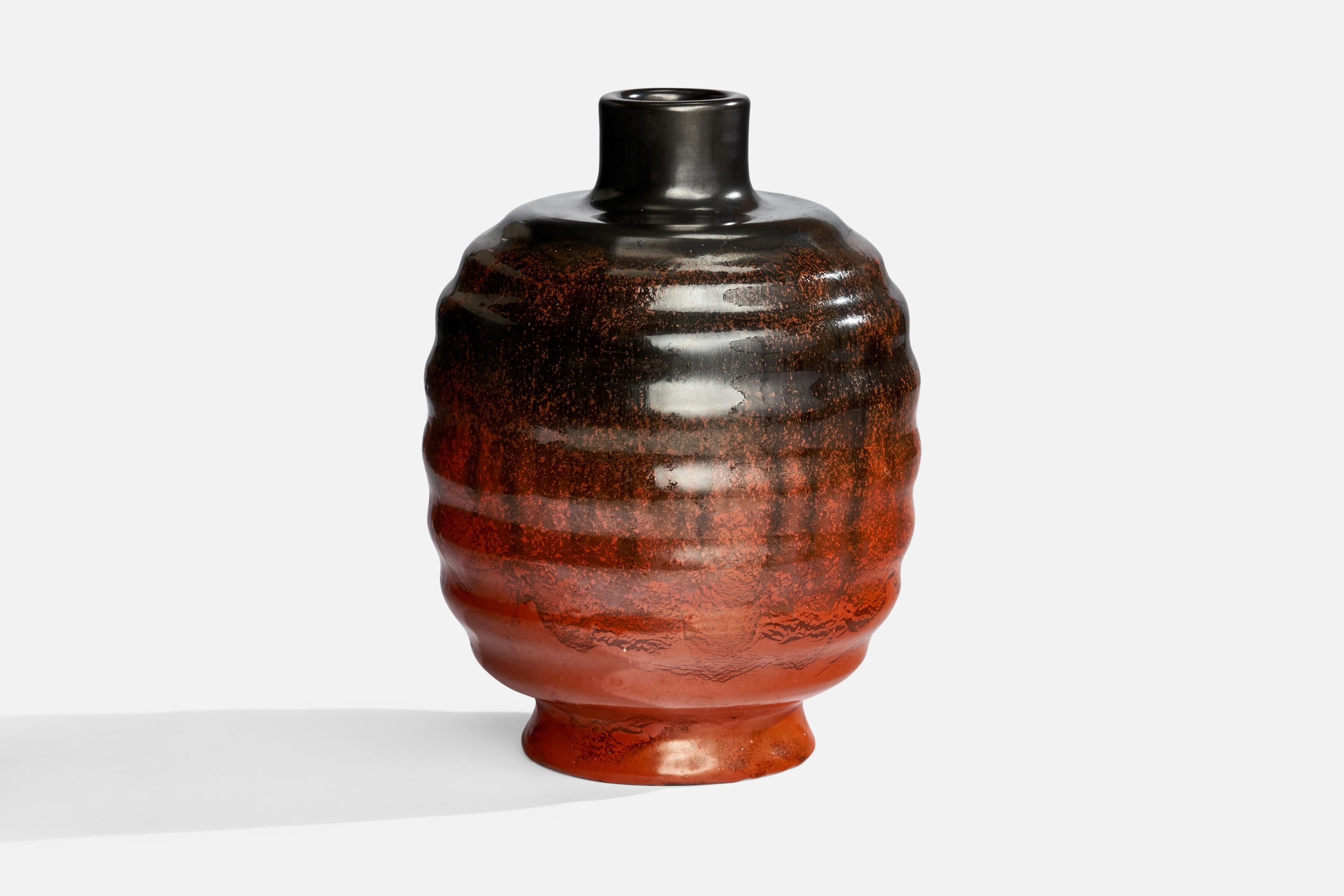 A black and orange-glazed earthenware vase designed and produced by Upsala Ekeby, Sweden, 1930s.