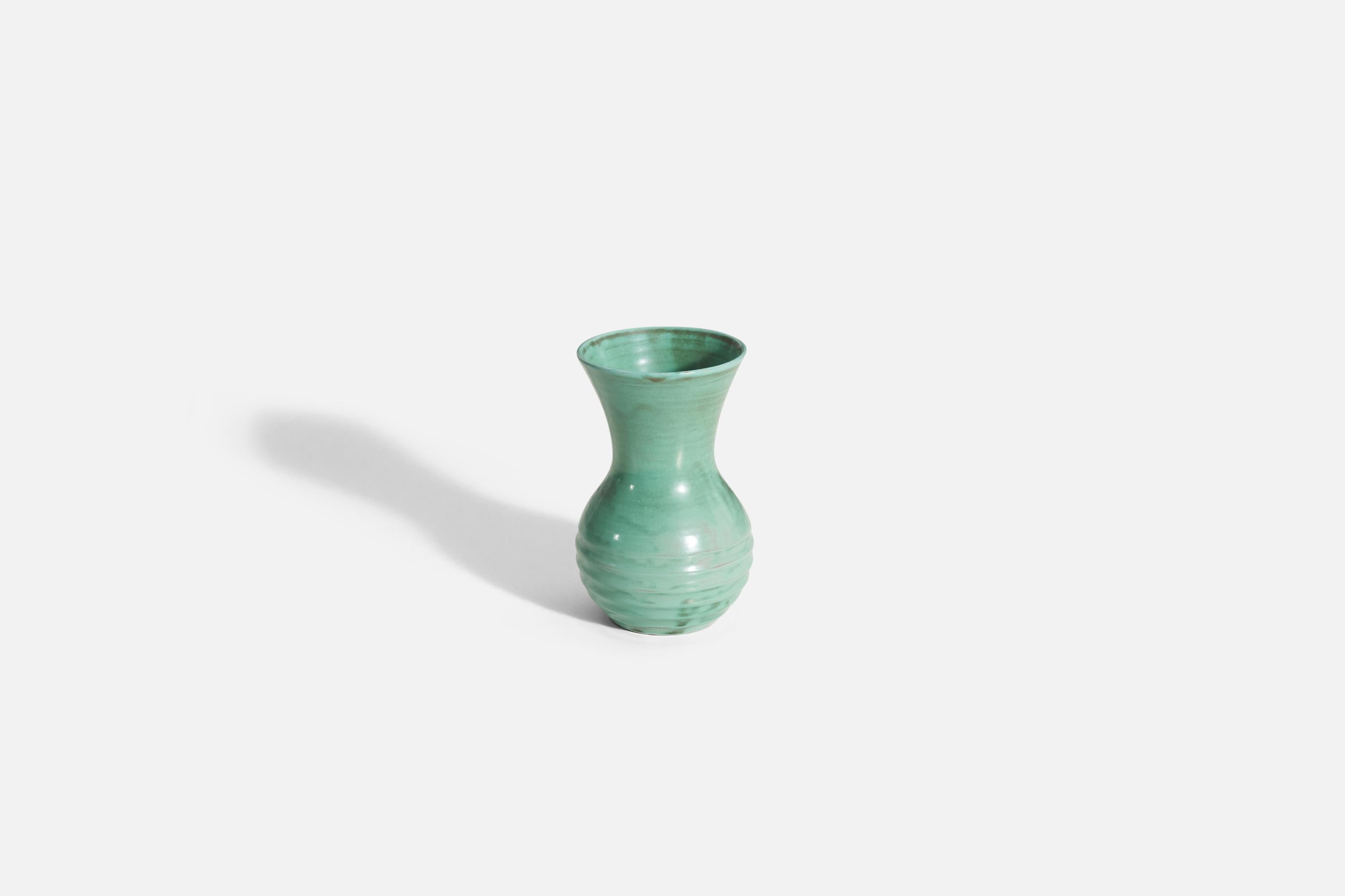 A green glazed earthenware vase produced by Upsala-Ekeby, Sweden, 1940s. 

Other designers of the period include Ettore Sottsass, Carl Harry Stålhane, Lisa Larsson, Axel Salto, and Arne Bang.