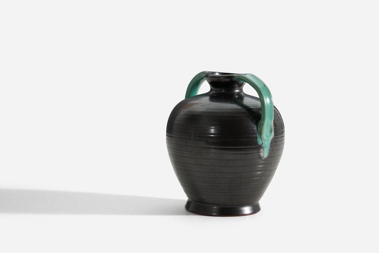 A green and black glazed earthenware vase. Produced by Upsala-Ekeby, Sweden, 1940s.

Other designers of the period include Ettore Sottsass, Carl Harry Stålhane, Lisa Larsson, Axel Salto, and Arne Bang.