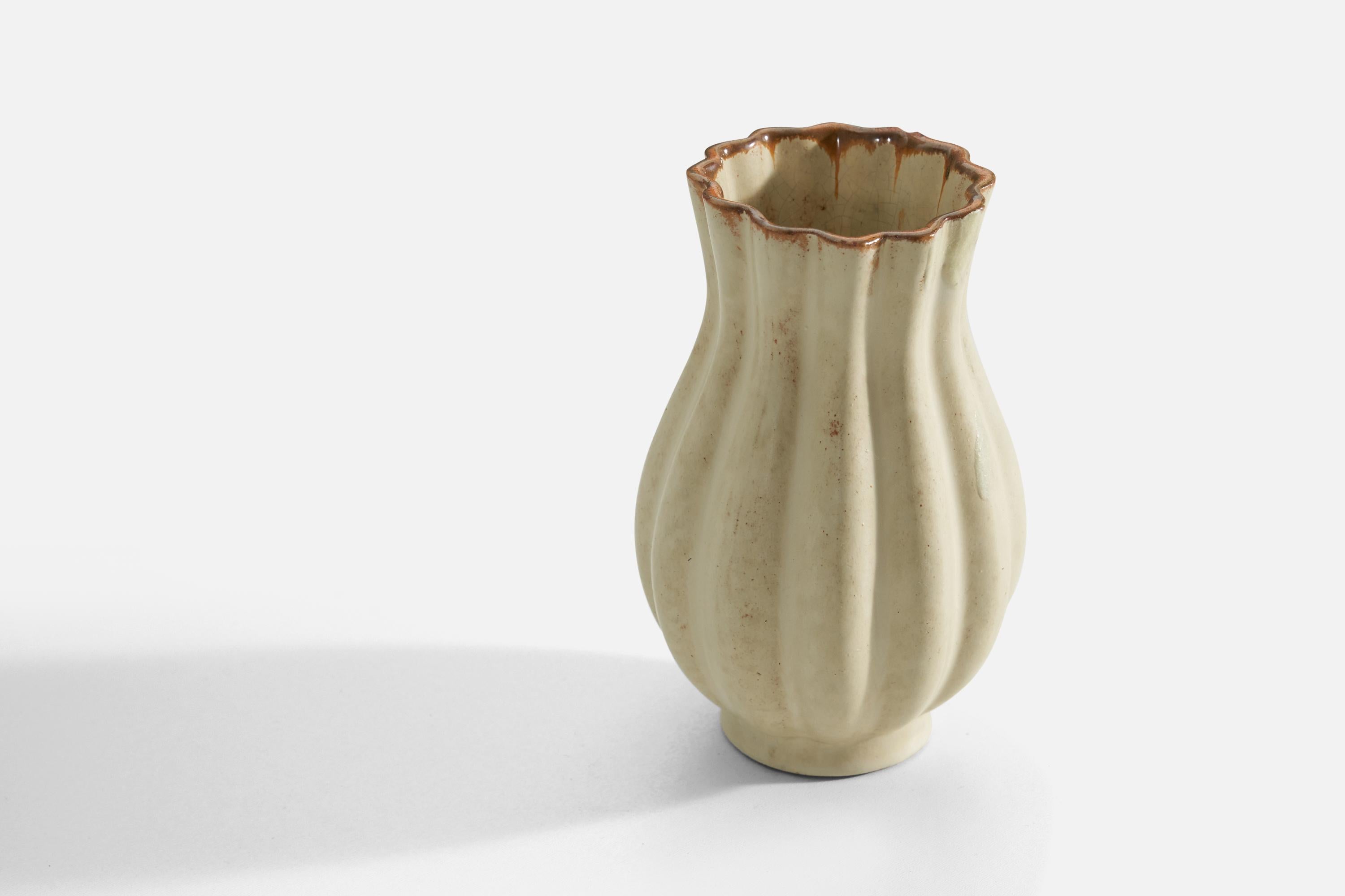 A vase. Produced by Upsala-Ekeby, Sweden, 1940s. Earthenware.

Other designers of the period include Ettore Sottsass, Carl Harry Stålhane, Lisa Larsson, Axel Salto, and Arne Bang.