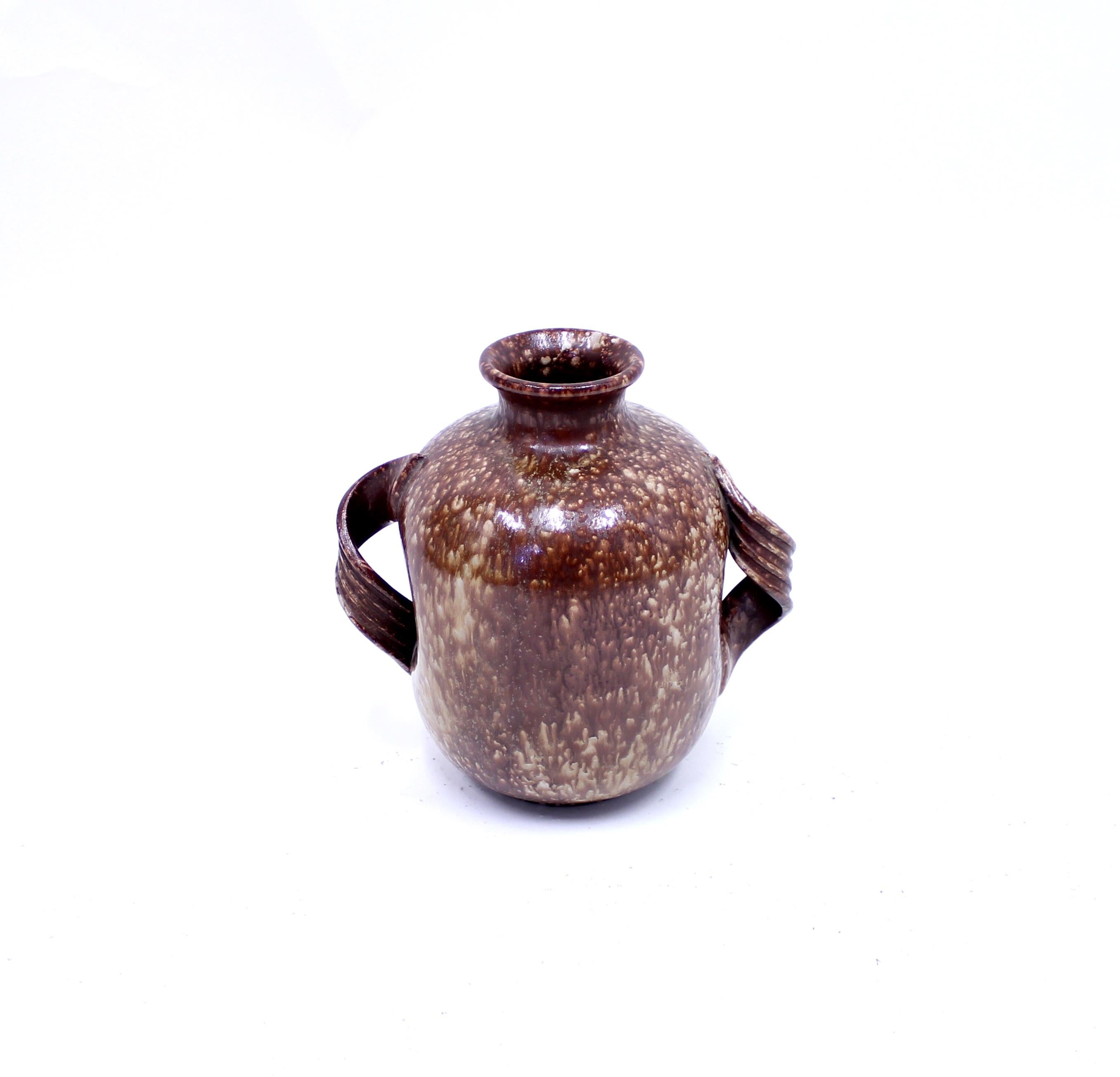 Vase or urn manufactured by Upsala-Ekeby in the early part of the 20th century, circa 1920. Red/brown and beige glaze. Model with two handles. Stamped 