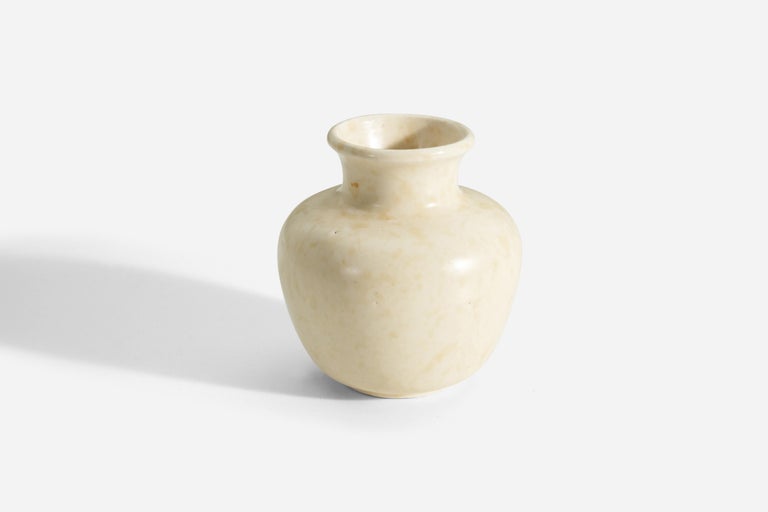 A white / beige-glazed earthenware vase designed and produced by Upsala Ekeby, Sweden, c. 1930s-1940s.