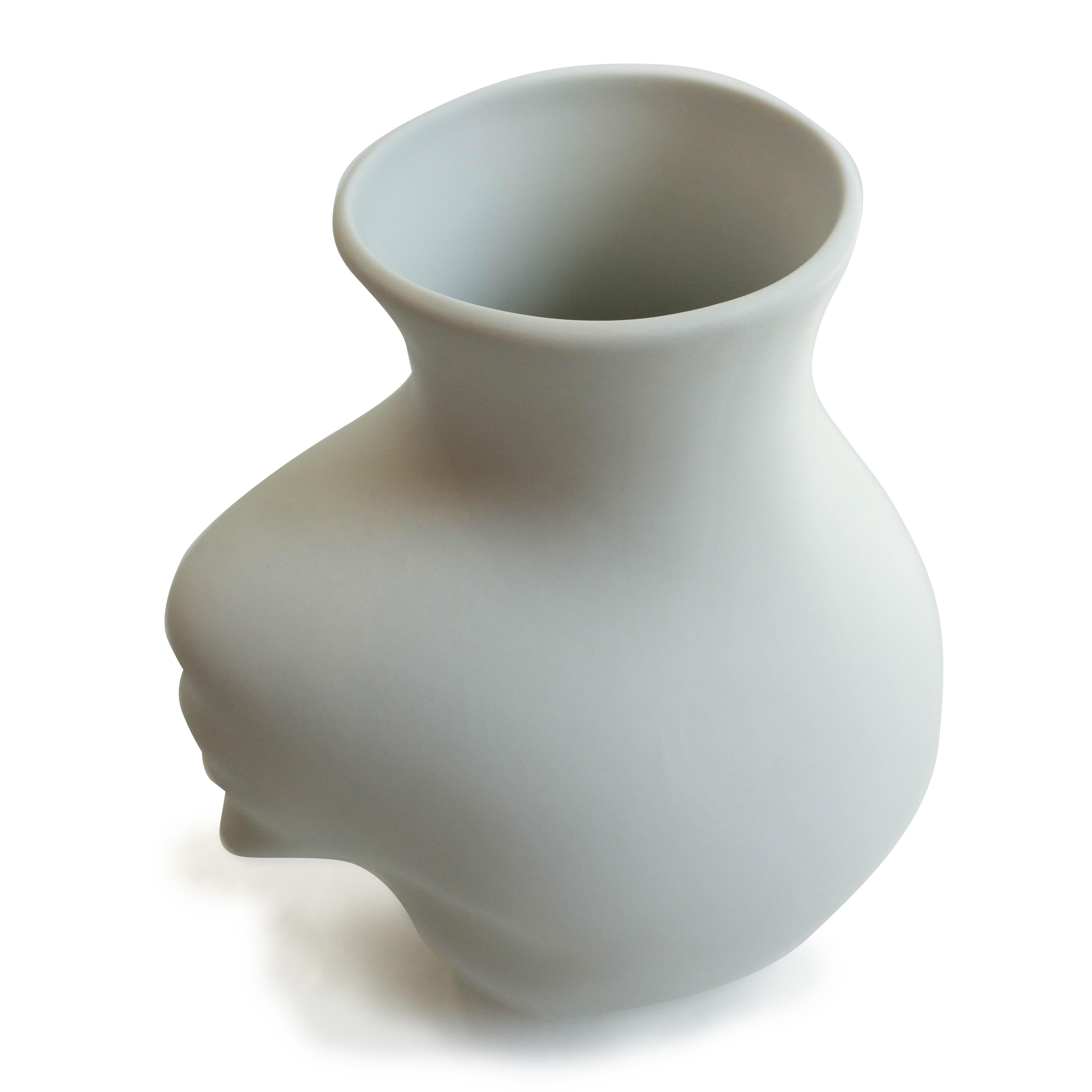 Designed by Koens & Middelkoop, this vase is unglazed porcelain sculpted into a human head shape. 

Dimensions: 10”H x 6”W x 8”L