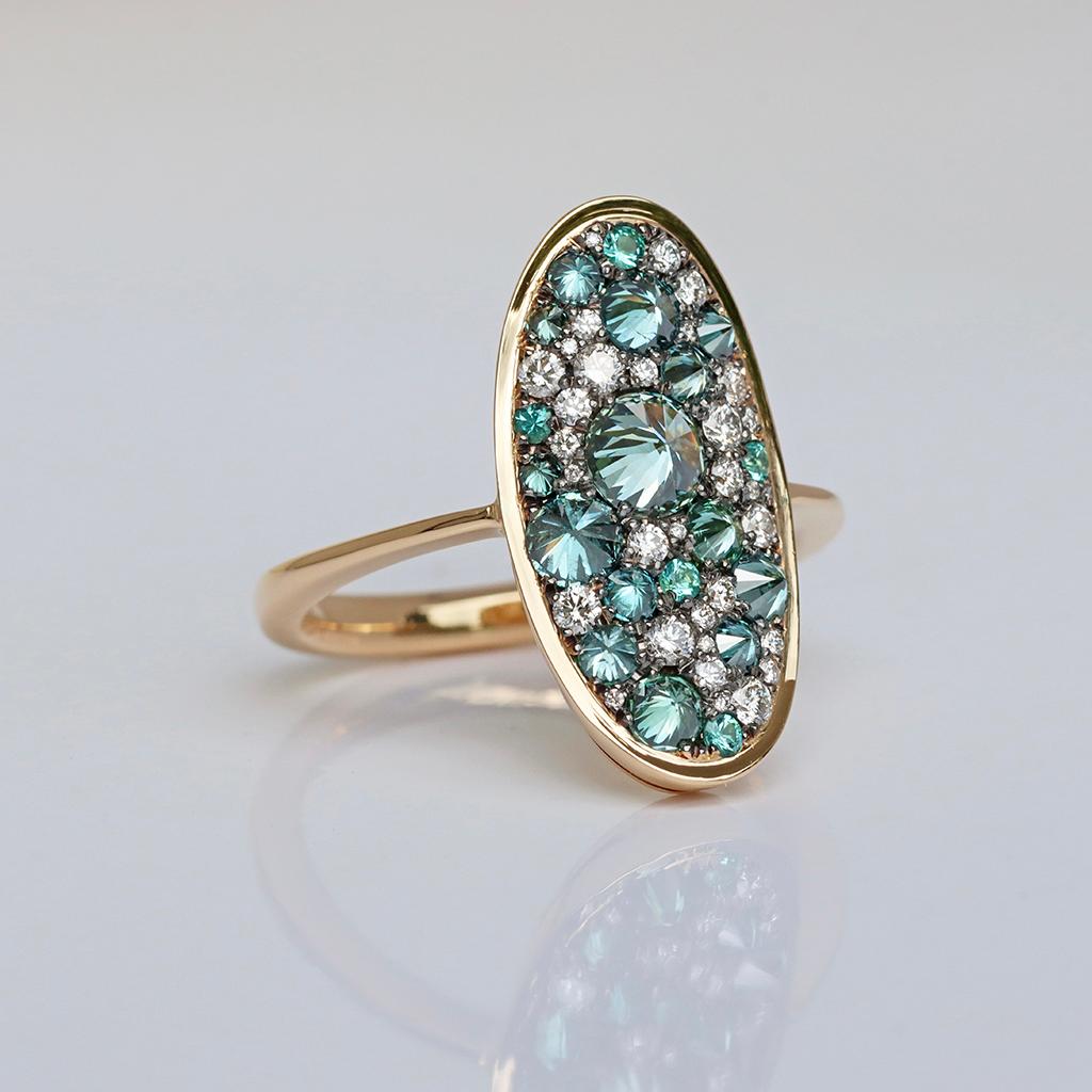 This ring in yellow gold, handmade in Belgium by jewellery designer Joke Quick, showcases a stunning mosaic of inverted blue diamonds, dazzling white diamonds, and Paraiba Tourmalines. 
Expertly handcrafted without casting or printing, it promises a