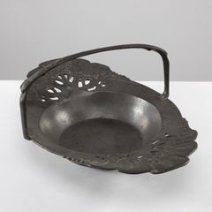 Urania. An Art Nouveau pewter fruit bowl with a loop handle floral decoration