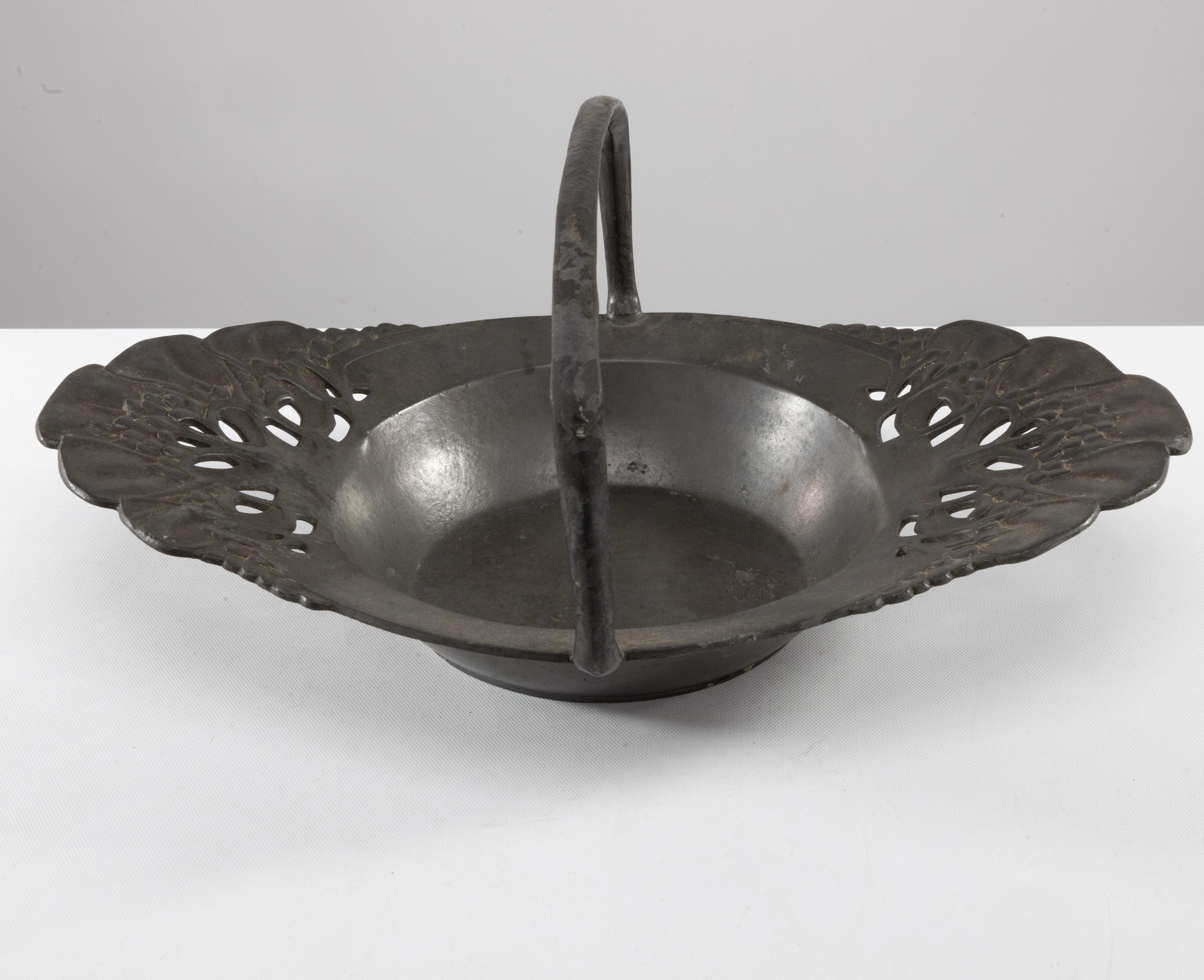 English Urania. An Art Nouveau pewter fruit bowl with a loop handle floral decoration For Sale