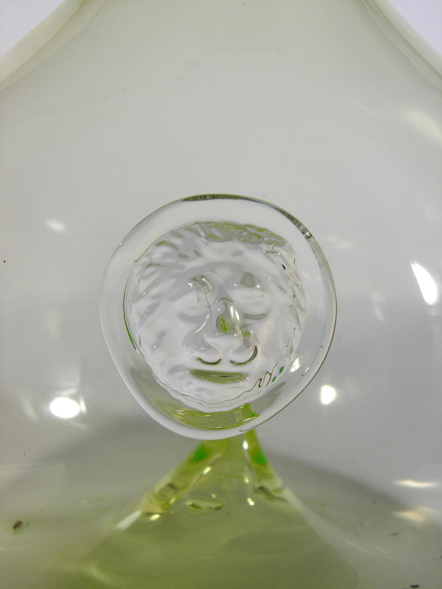 Handmade bottle made of uranium glass with a sculpture of a lion's head, Water or wine bottle, A suitable gift for a man or a woman in the sign of a lion, Made probably in the Czech Republic, 19-20th century, - undamaged.
 
