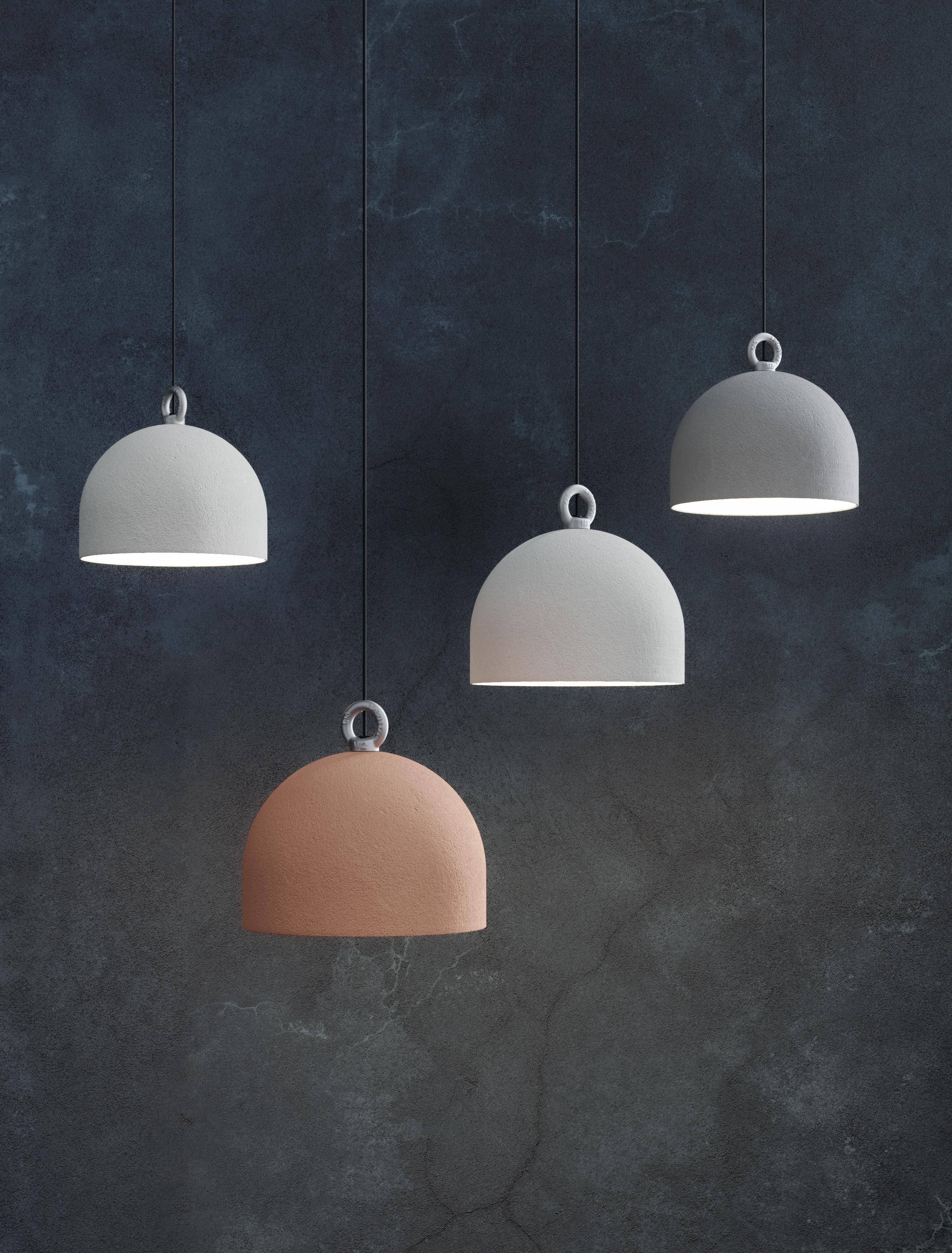 Taking inspiration from the bollards found in the urban landscape, Urban Concrete is a lighting piece balancing clean lines and solid surfaces with a dome crowned by a lifting hook.

Whilst the spun metal dome evokes a cement block and creates an