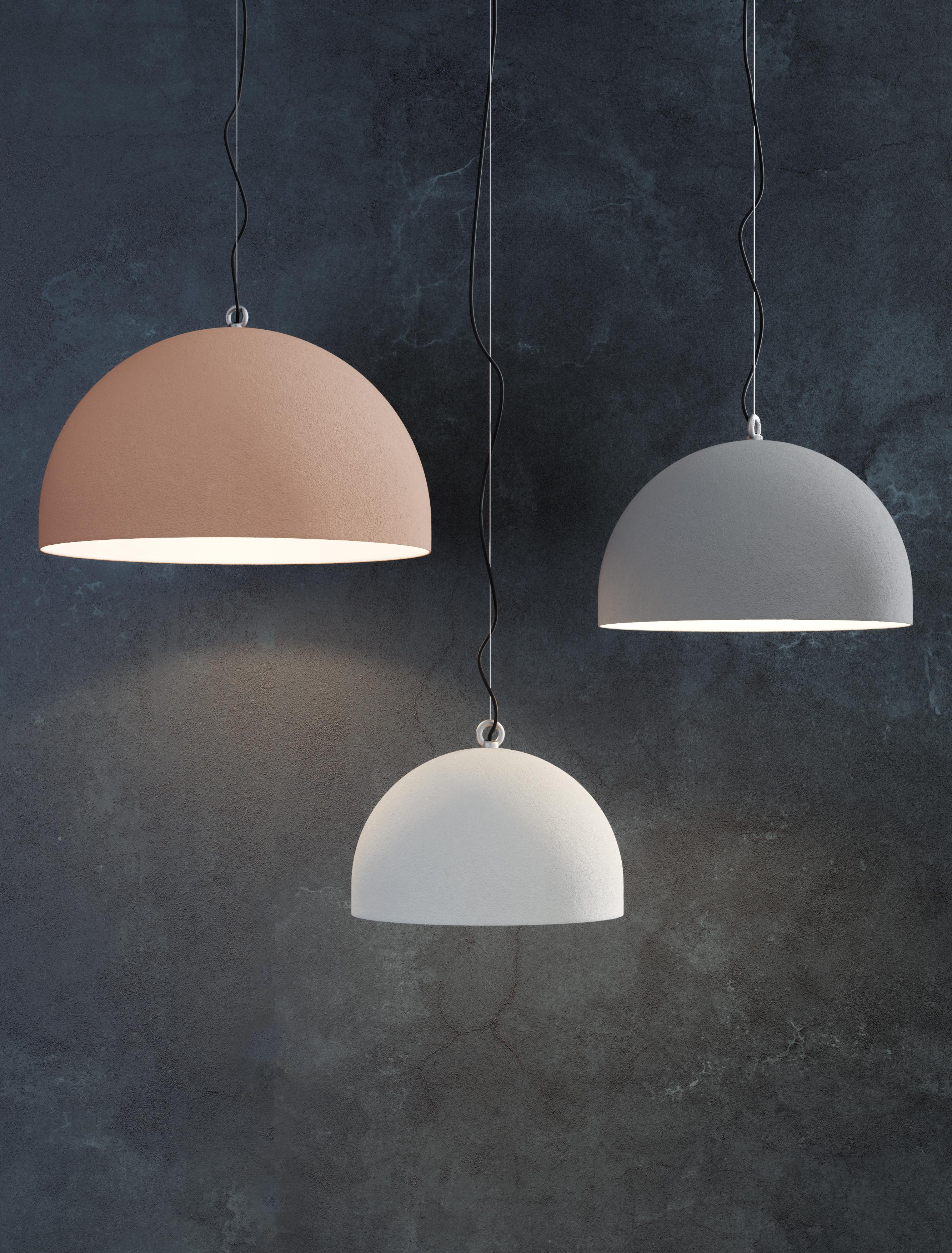 Taking inspiration from the bollards found in the urban landscape, Urban Concrete is a lighting piece balancing clean lines and solid surfaces with a dome crowned by a lifting hook.

Whilst the spun metal dome evokes a cement block and creates an