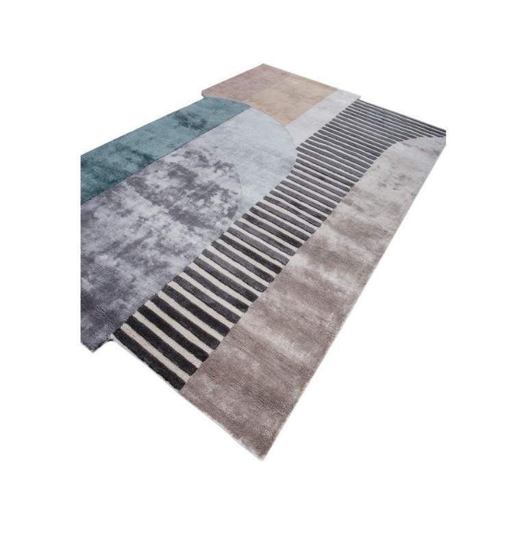 Like an avant-garde canvas on your floor, this modern hand-tufted rug from rural India is an artistic marvel. With a bold celebration of personalities, it unfolds like origami, creating a playful mosaic of shifting planes and joyful colors. Soft