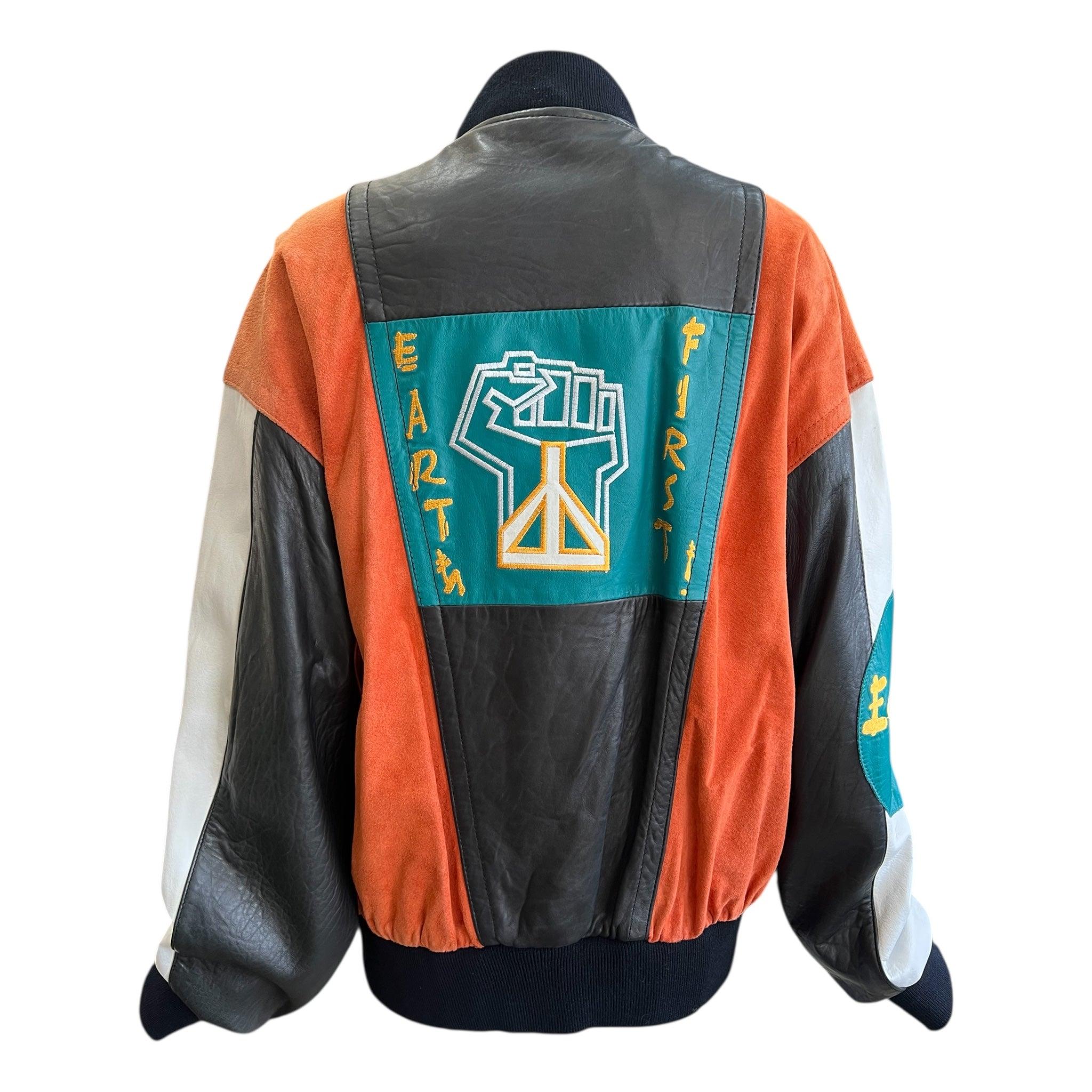 Urban Renewal by M Julian leather and suede bomber jacket. Circa late 80s. Black and white leather with contrasting rust orange suede. Teal leather patch on chest and sleeve with 