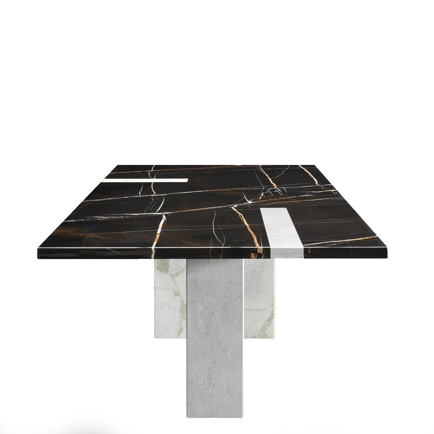 Two-tone means twice the luxury in the urban marble dining table by Giorgio Soressi. With a young silhouette, this version of the table is characterized by its juxtaposition of Sahara Noir with Grigio Carrara and Arabescato Vagli. The table,