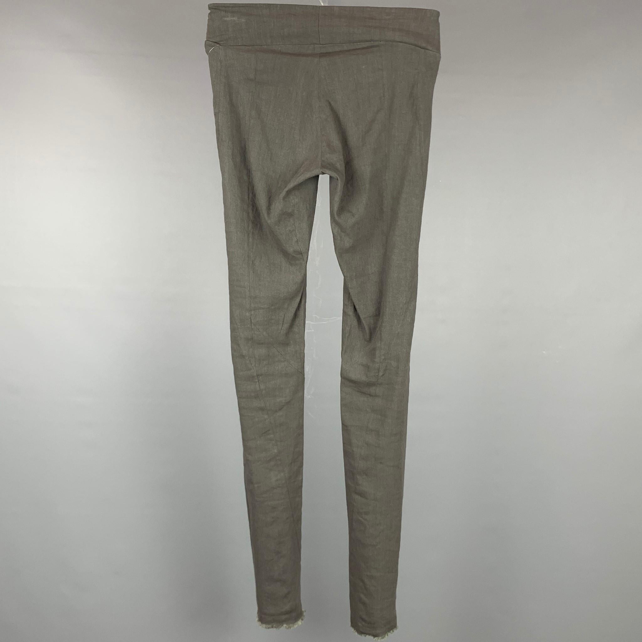 URBAN ZEN by DONNA KARAN leggings comes in a slate linen featuring a slip on style, fringe hem, and a skinny fit.

Good Pre-Owned Condition.
Marked: 2

Measurements:

Waist: 24 in.
Rise: 7 in.
Inseam: 33 in.