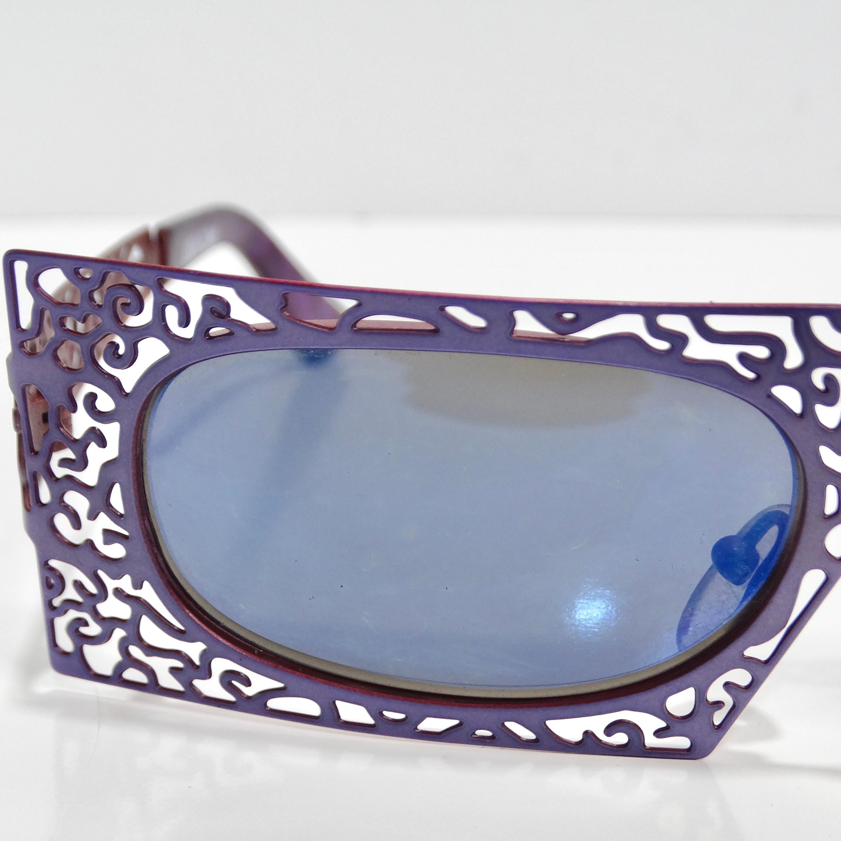 Introducing the Urbani Venice Purple Laser Cut Sunglasses, a stunning pair of statement sunglasses that exude vintage charm and contemporary flair. Crafted in the 1980s, these sunglasses are a true testament to timeless style and bold design.

These