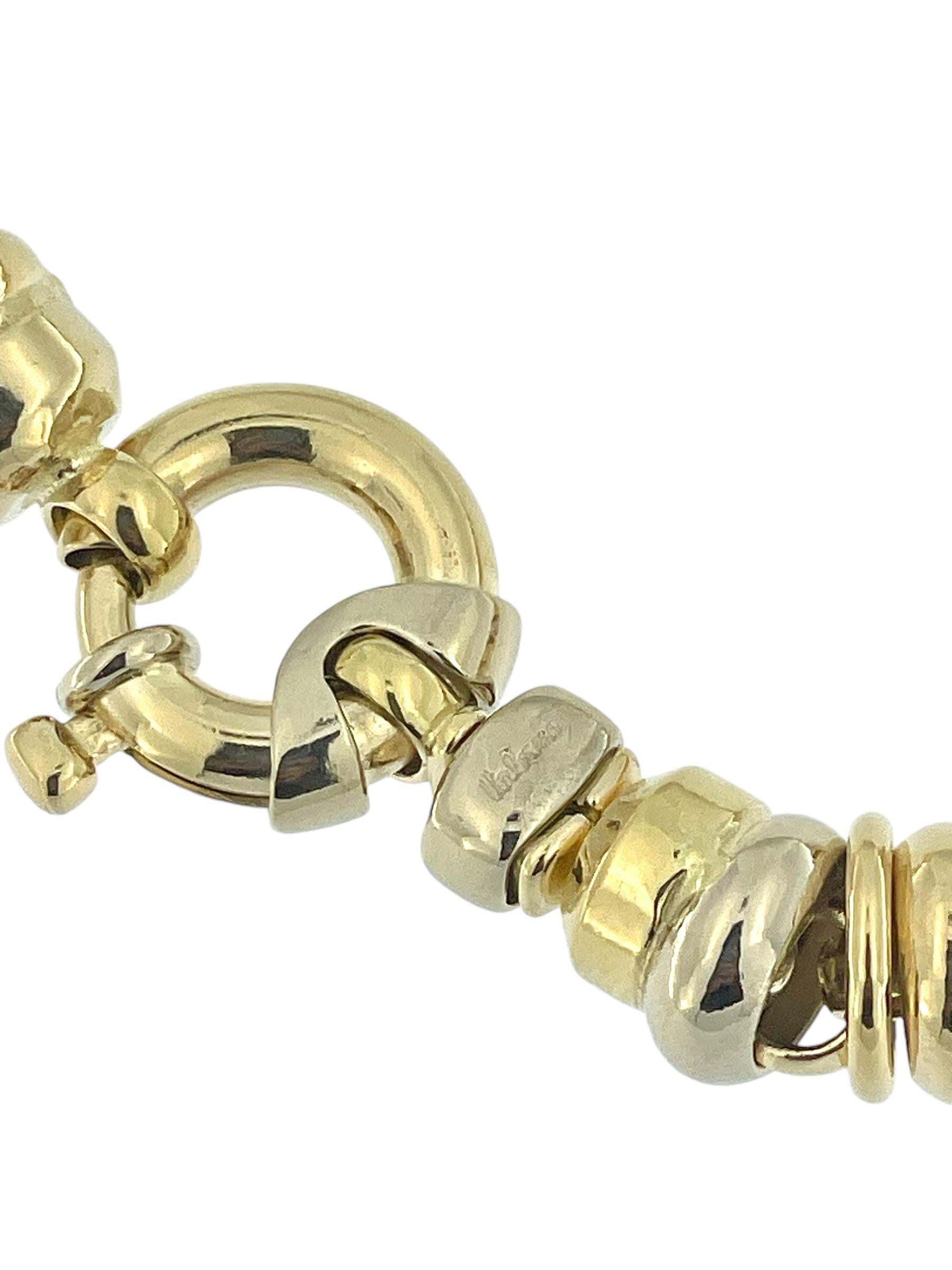 The Urbino Yellow and White Gold Tubular Necklace is a distinctive and artistic piece crafted in 18kt gold, known for its dynamic and fluid design. This necklace features a link structure with alternating yellow and white gold large and thin