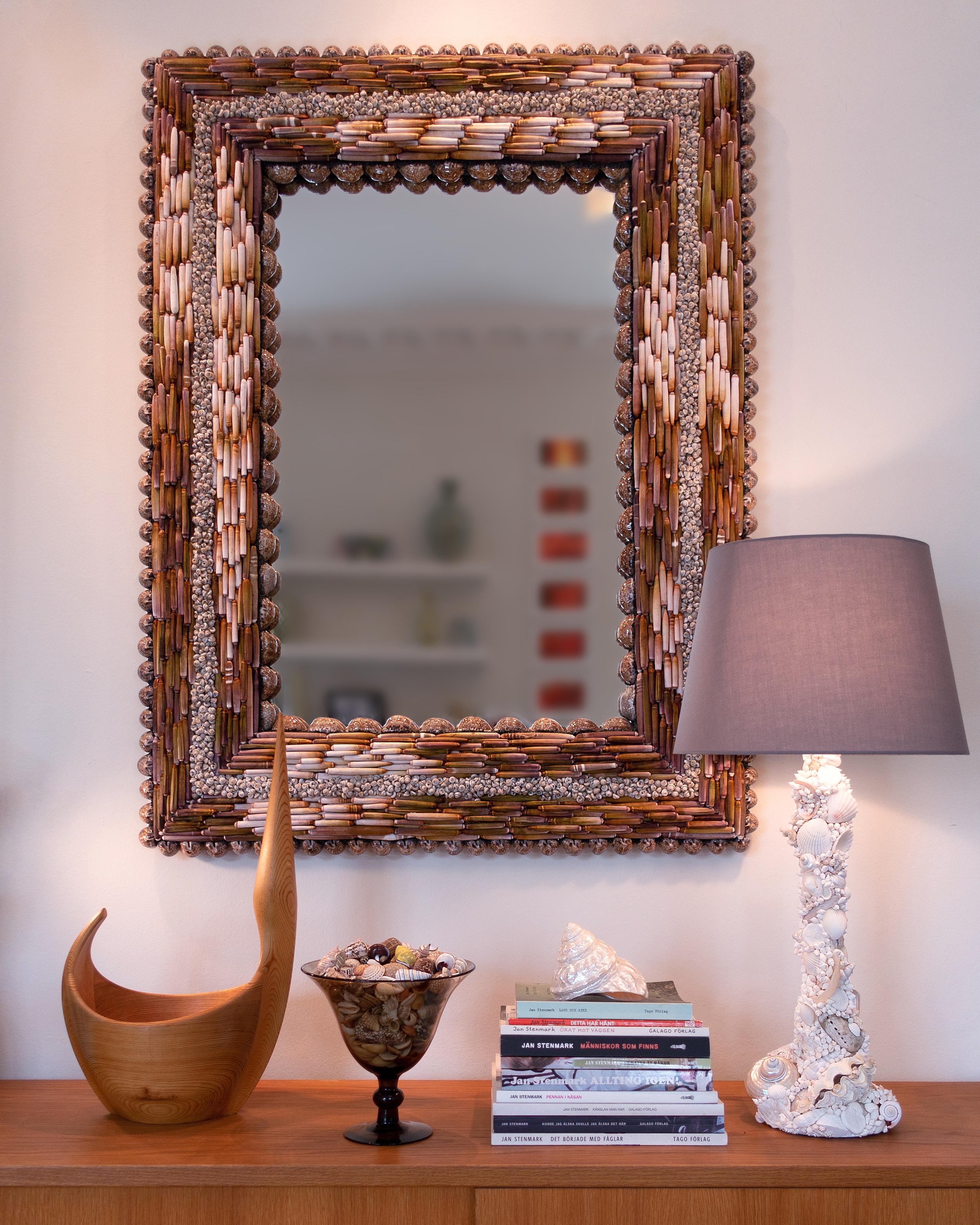 Urchin Pearls, unique shell mirror by Shellman Scandinavia in Sweden.

A strictly patterned shell mirror using only four “ingredients” from sea and beach: shiny Arabic cowries lining both inner and outer edges, urchin spines in beautiful color