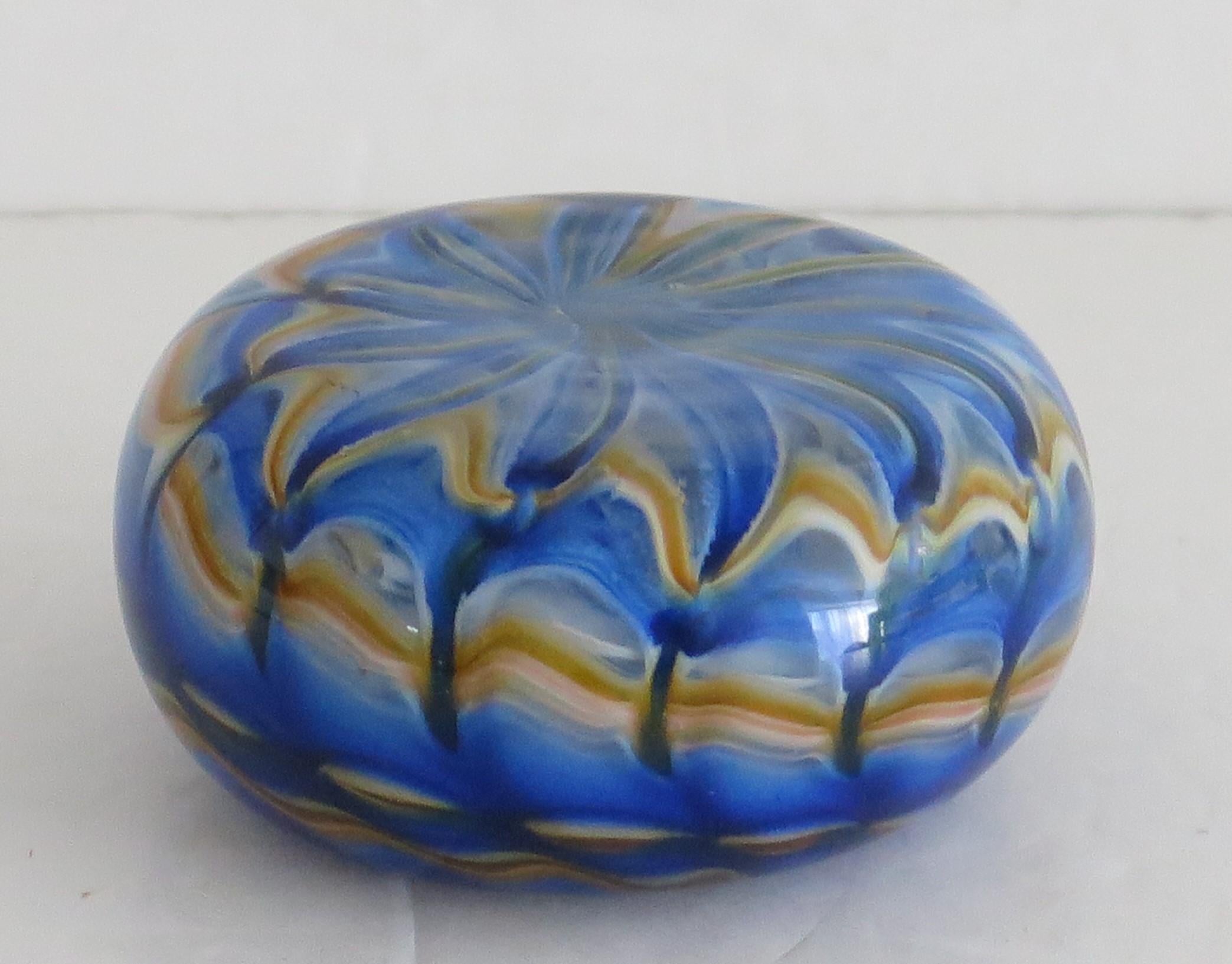 This is an unusual hand-made Art-Glass paperweight from Uredale Glass, Masham, North Yorkshire, England which we date to the late 20th century.

The paperweight is hand made in the shape of a pebble. This is an individual fused glass piece with a