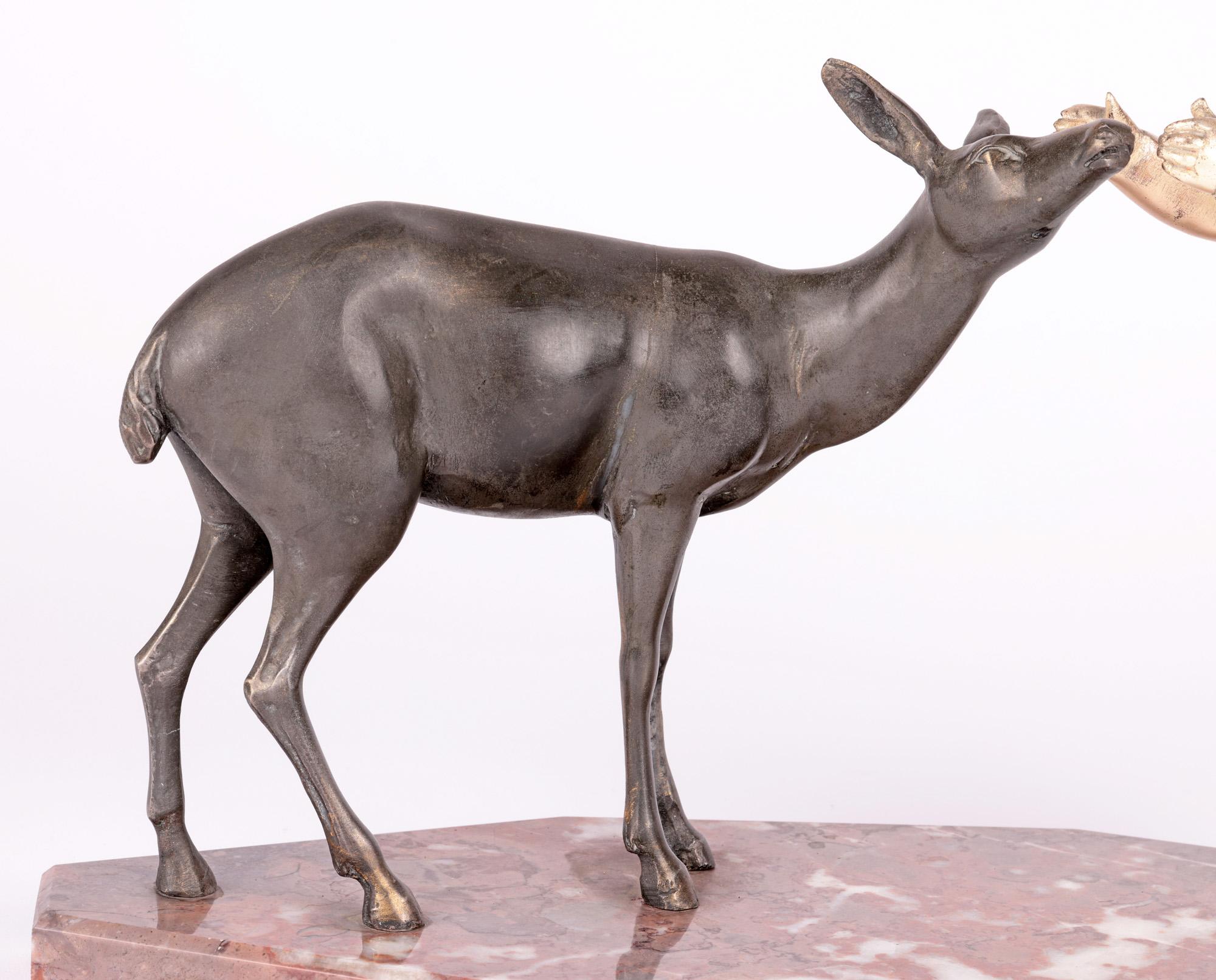 A stylish French Art Deco silvered sculpture young child with deer 
a very stylish French Art Deco sculpture of a young child with a young deer mounted on a red marble base by Uriano and dating from around 1925. The sculpture portrays a metal cast