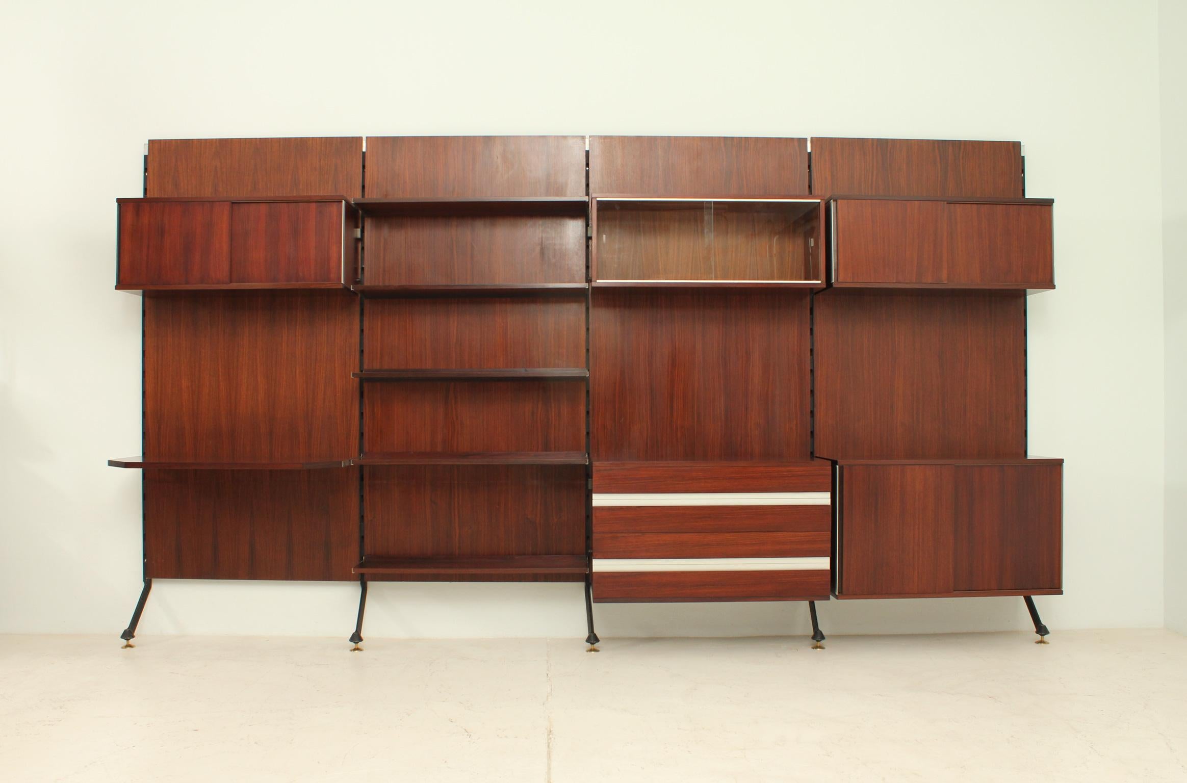 Urio wall system in hardwood designed in 1957 by Ico Parisi for MIM Roma, Italy. Different elements including shelves, desk, chest of drawers and cupboards with sliding doors.
