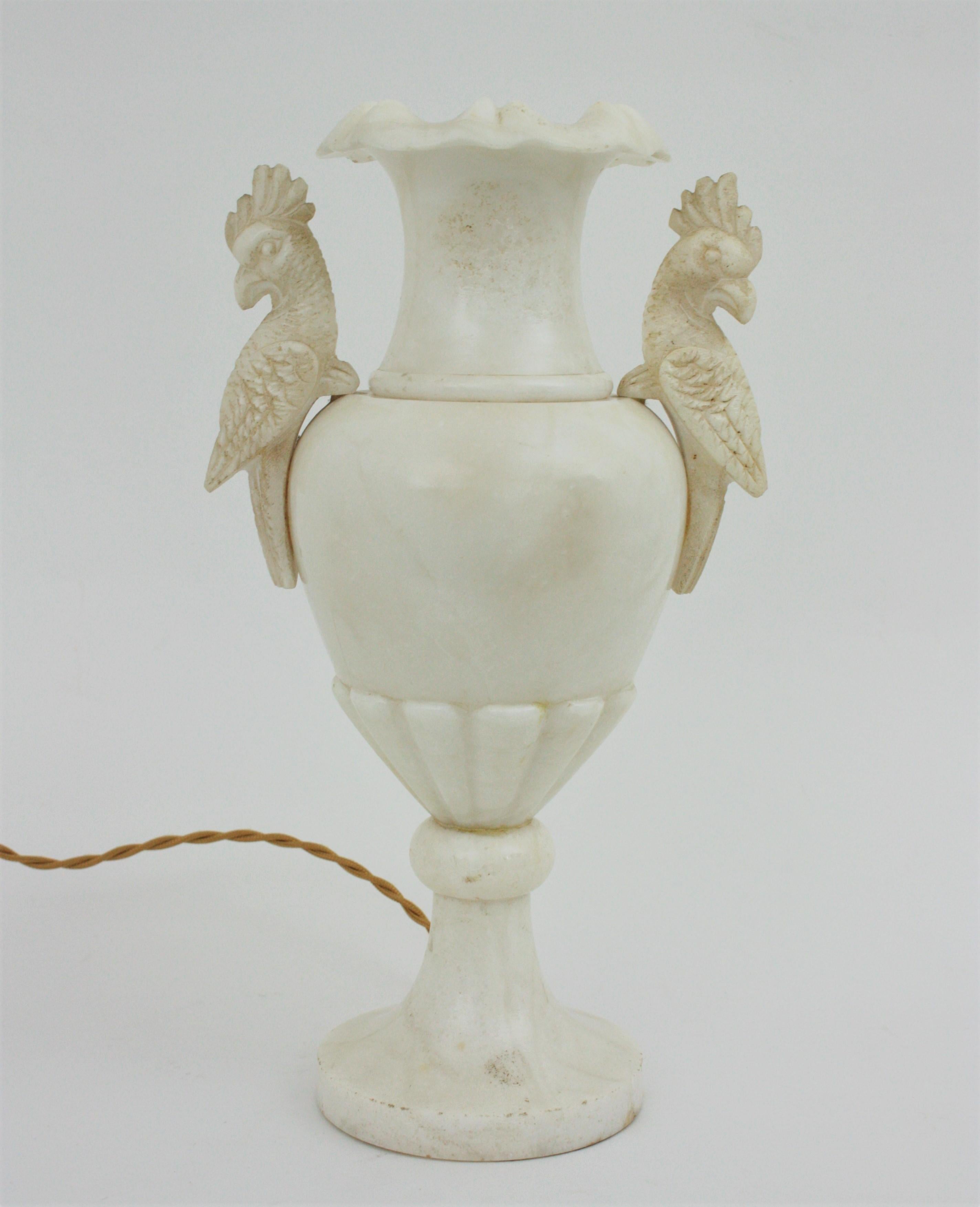 Twin-handled urn table lamp with carved parrot details. Spain, 1930s
This eye-catching alabaster urn lamp has an elegant neoclassical design. The carving parrots handles mark the difference in this piece. Manufactured at the art deco period.
Place