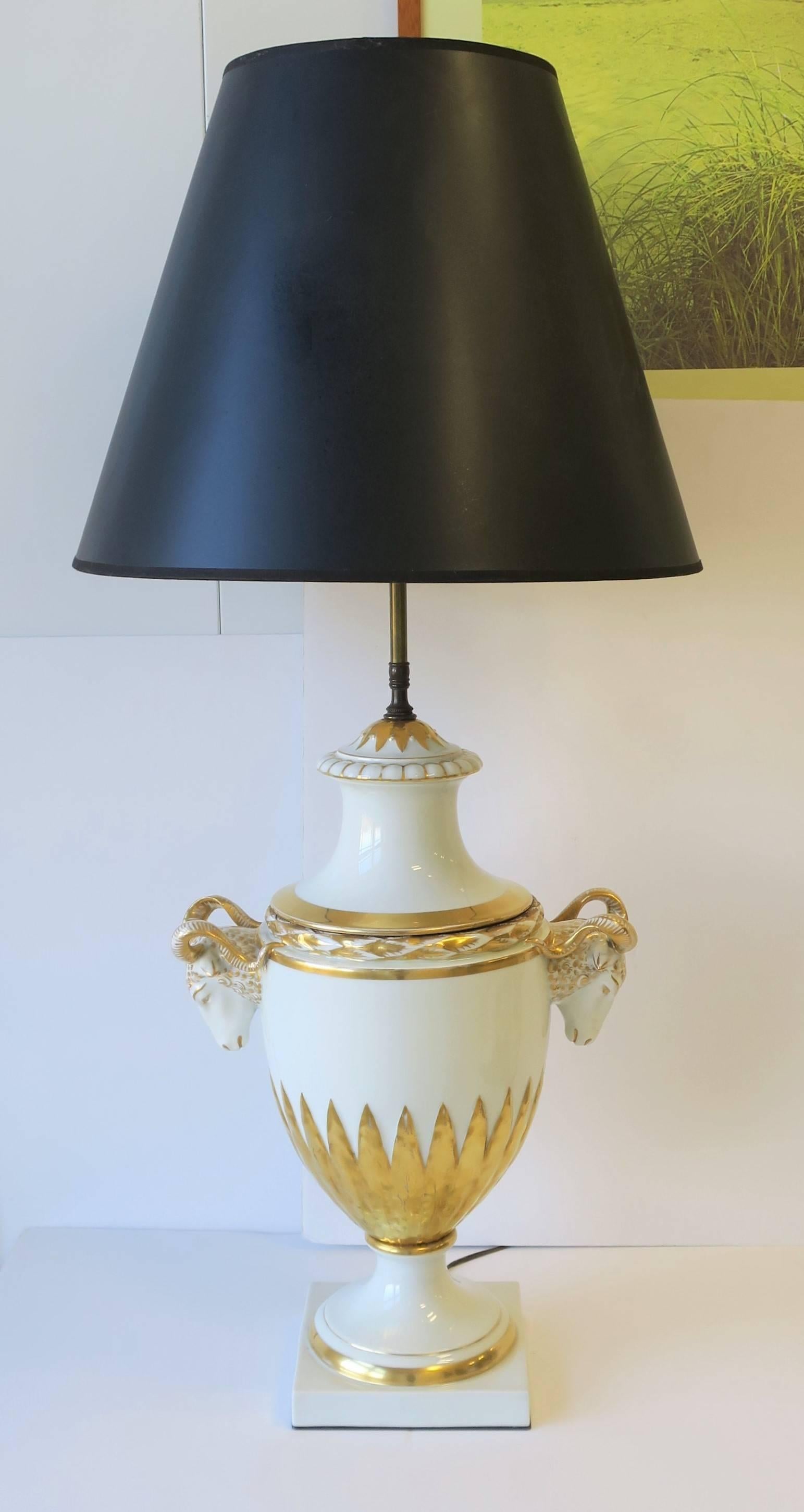 A gorgeous large white and gold porcelain table lamp in urn form with detailed ram's head design, in the Empire style, attributed to Furstenberg Porcelain, Germany, circa 20th century. Beautiful detail from top to bottom as shown in images. Lamp