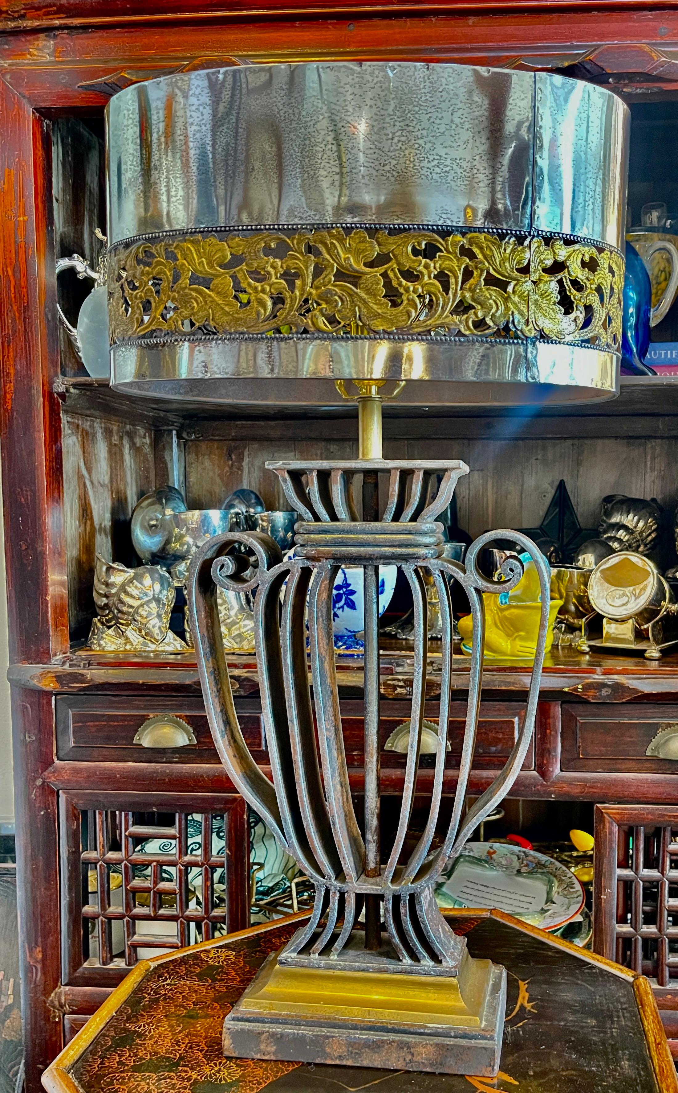 Very pleased to present you with very rare and unusual and very heavy  Neoclassical French Wrought Iron table lamp, 1940s
This urn form table lamp has a very unusual polished metal and highly detailed oval shade. 
To my knowledge this lamp was