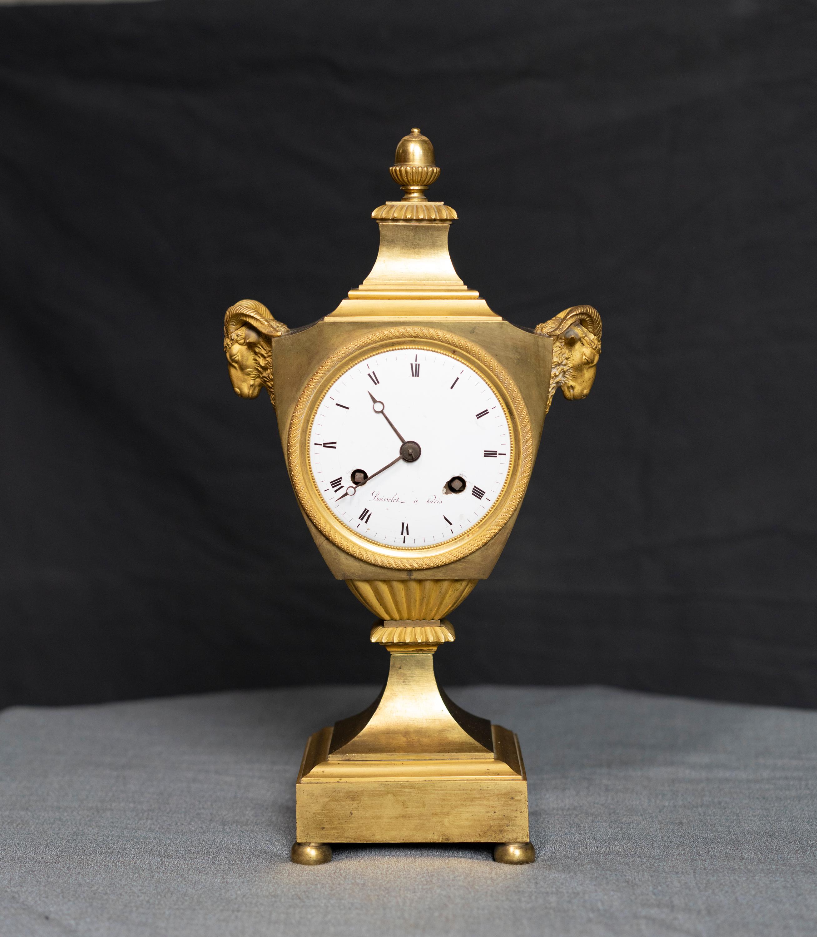 Urn shaped Louis XVI period gilt bronze rams head clock signed on dial: 