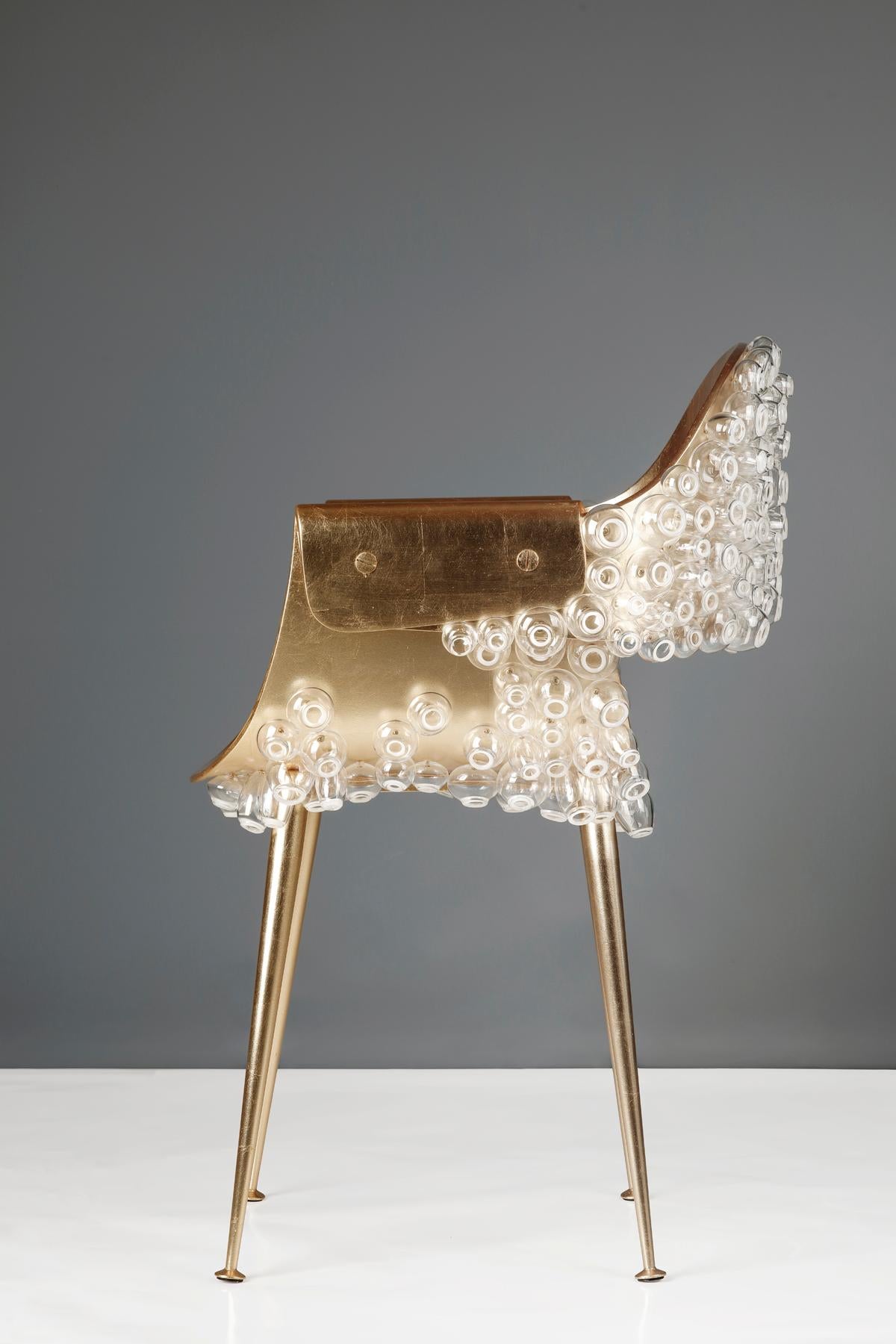 The traditional stability of metal and fragility of glass are juxtaposed in this dreamlike subaqueous chair. To rest in this chair is to collude in the subversion of conventional materiality, where one can be supported by barnacles made of glass.