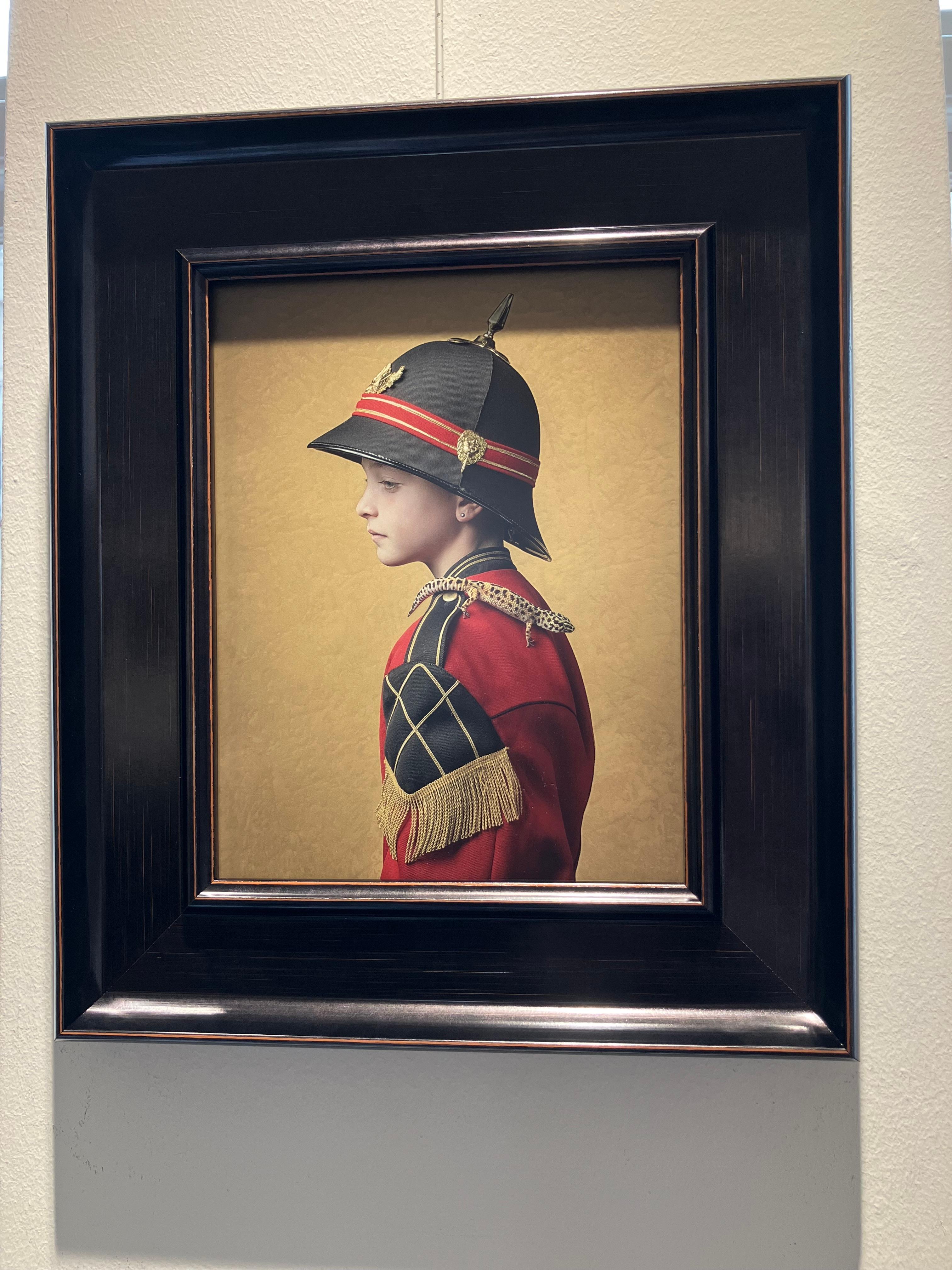 ''Lukah 2'' Dutch Contemporary Portrait of a Boy in Red Uniform with Gecko - Photograph by Ursula van de Bunte