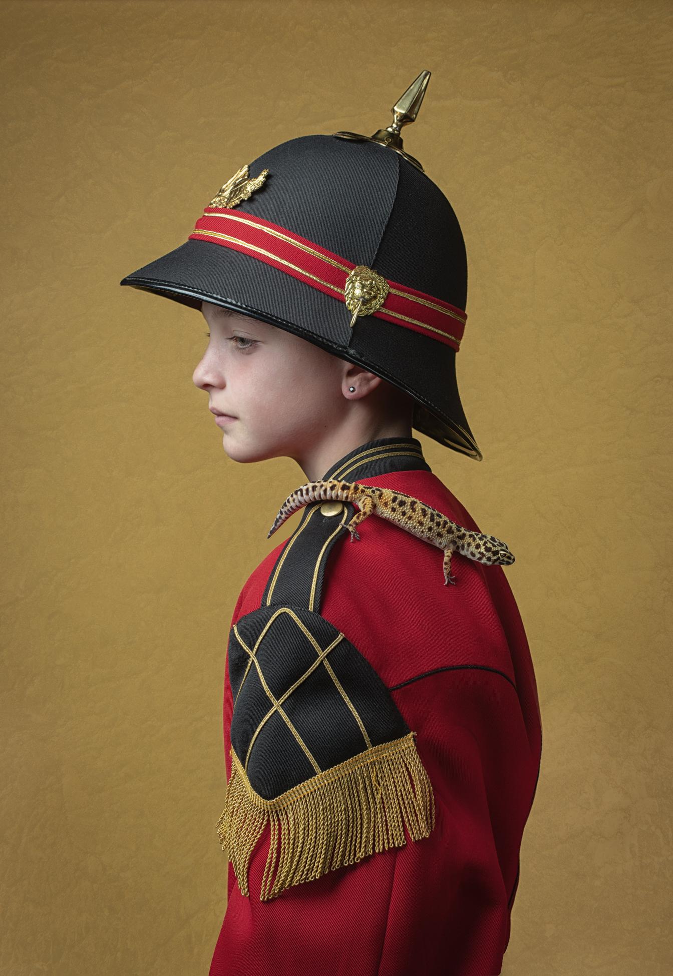 Ursula van de Bunte Portrait Photograph - ''Lukah 2'' Dutch Contemporary Portrait of Boy in Red Uniform with Lizard