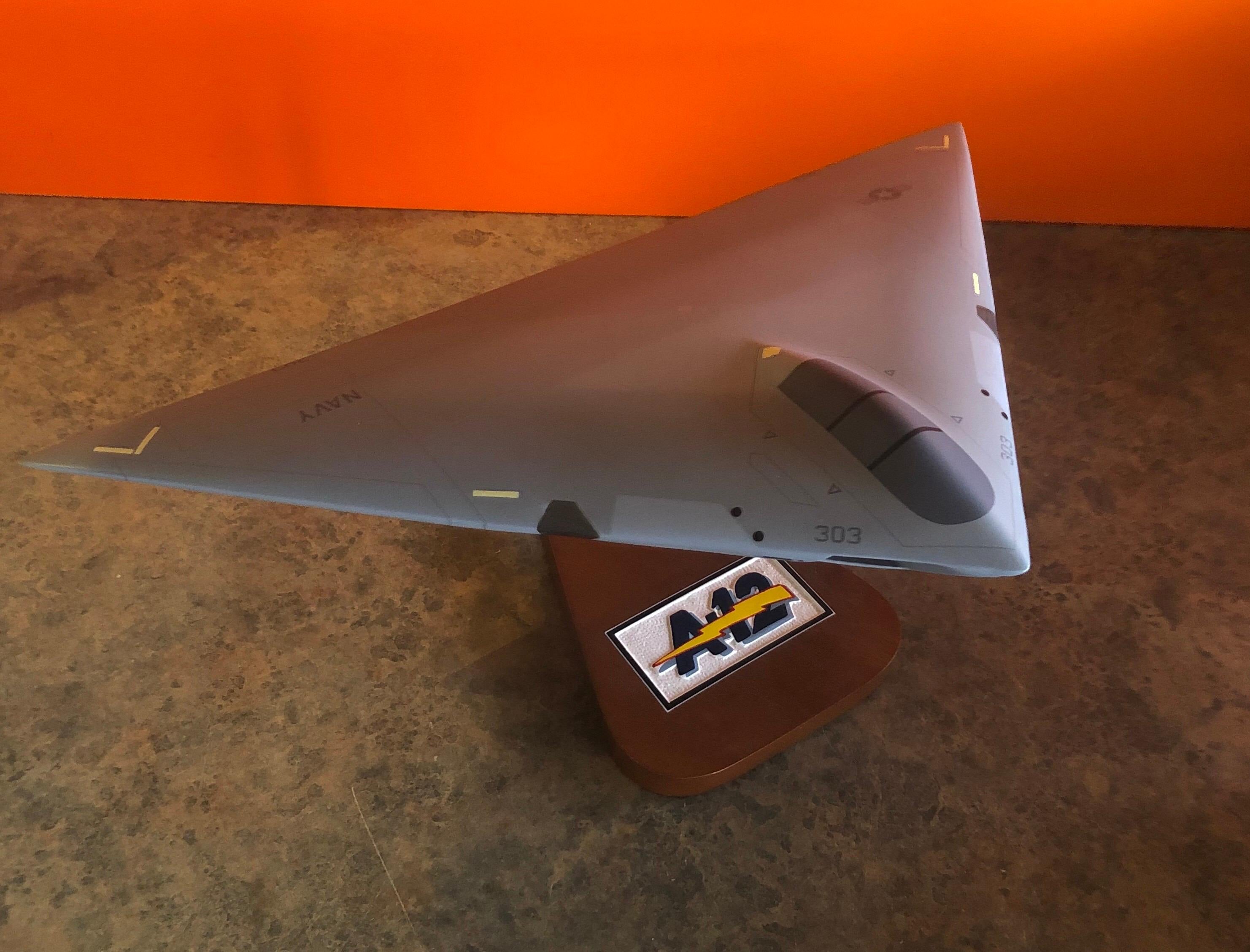 A very cool and rare U.S. Air Force A-12 Avenger II contractor desk model, circa late 1980s. The piece is in very good condition and super high quality. It is made of wood and mounted on a triangular wooden base with stainless steel support beam;