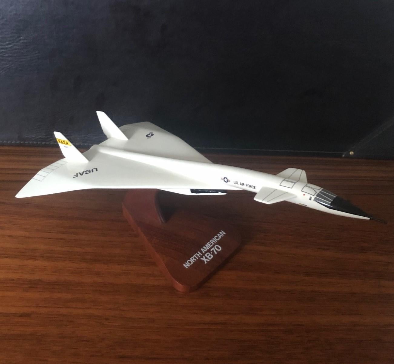 A very cool U.S. Air Force NASA XB-70 Valkyrie airplane / bomber desk model, circa 1970s. The piece is in very good condition and super high quality. 
 is made of wood and mounted on a triangular wooden base; The plane has a white lacquer finish