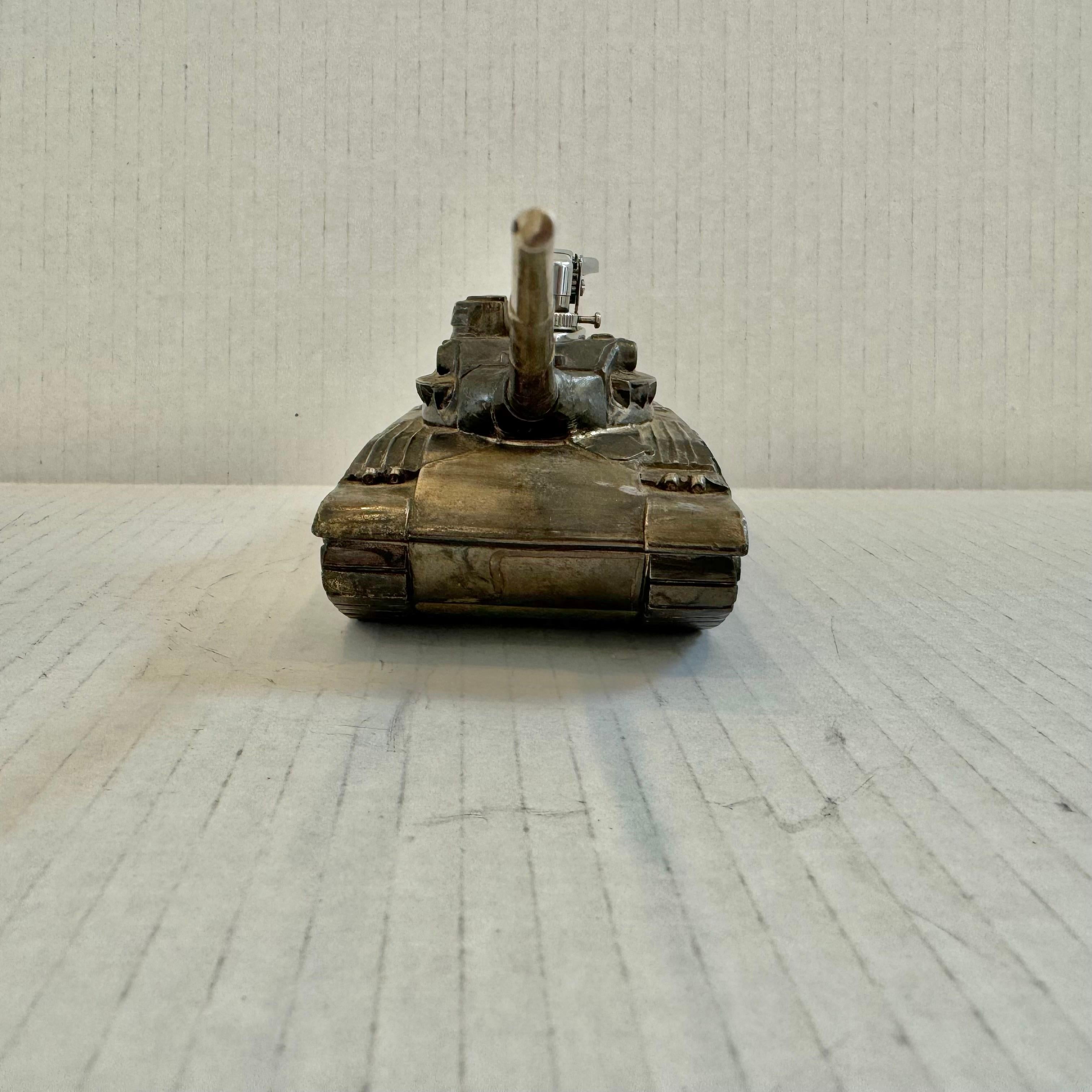 Cool vintage table lighter in the shape of a Military Tank. Made in Japan, 1980s. This piece has great balance and details. Cool tobacco accessory and conversation piece. Working lighter. Good vintage condition.