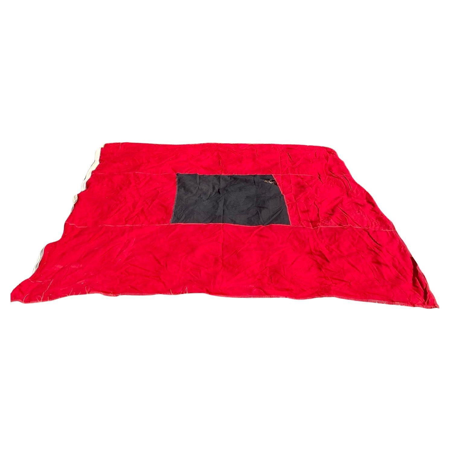 Vintage U.S. Coast Guard Hurricane or storm warning flag, circa 1930s, or possibly 1940s, a machine stitched wool bunting flag with black square on red field, with reinforced corners near the manila bunt-line. One of these flown by itself at a Coast