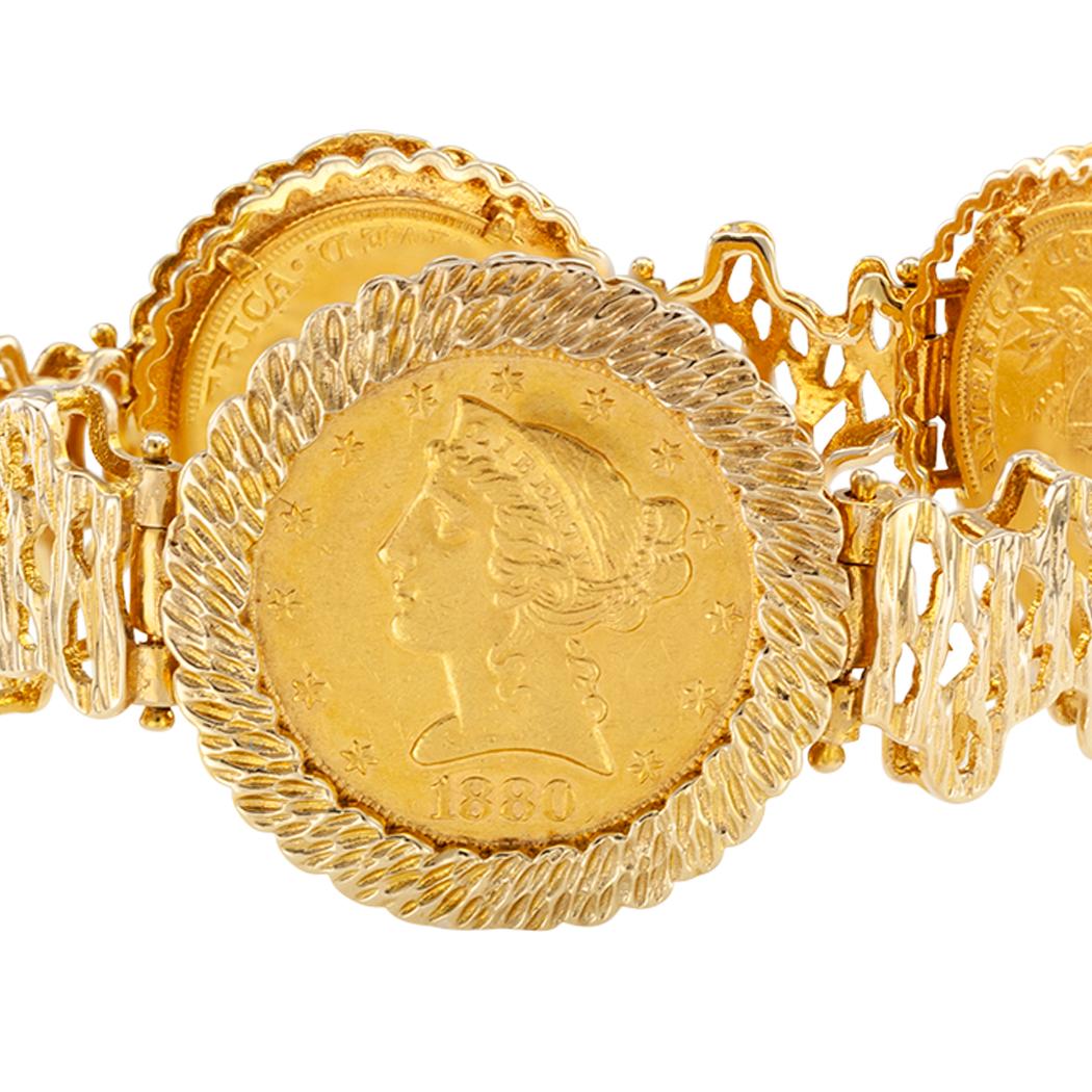 United States Gold Liberty coin bracelet circa 1970. Showcasing four $5.00 gold US Liberty coins dated 1880, 1882, 1901 and 1906, bezel-set on a flexible, 14-karat yellow gold link bracelet. The bezels embellished by a tree bark texture and the