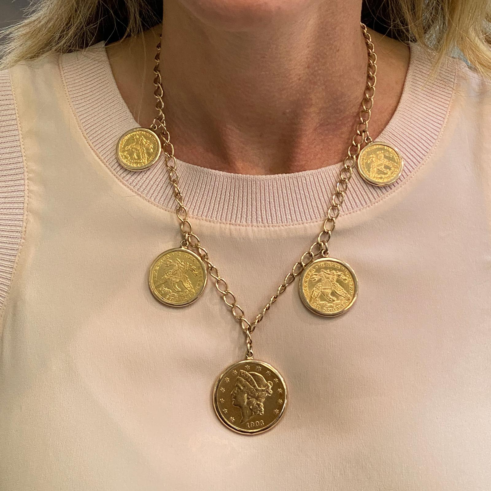 US Gold Coin dangle necklace fashioned in 90% gold coins and 14 karat yellow gold. The necklace features 1-$20 US gold coin, 2-$10 US gold coins, and 2-$5 US gold coins dangling from an open 18 inch gold chain. The net weight of the coins is 93