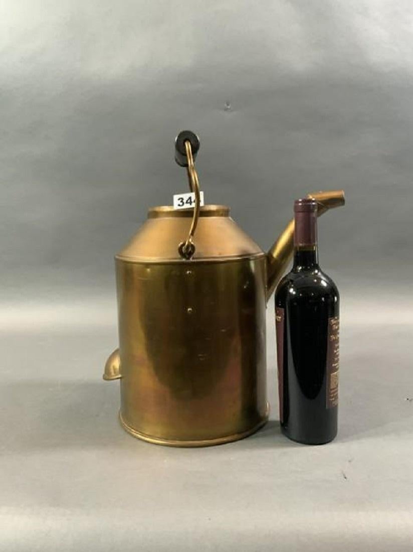 Solid copper US lighthouse Service oil can embossed US lighthouse Service on the bottom. Substantial in size. Fitted with wood handle and lid on chain. Historic lifesaving relic.

Overall dimensions: 12