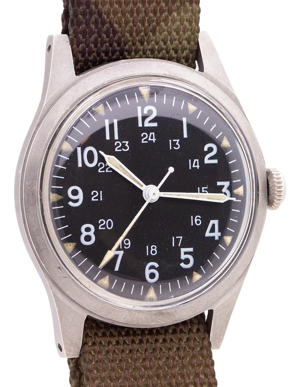   
US Military issue Benrus man’s wristwatch, circa 1970, Vitenam era. Featuring 34 X 41mm non reflective brushed finish base metal case, acrylic crystal, and original matte black dial with 24 hour indexes and triangular luminous hour indexes,