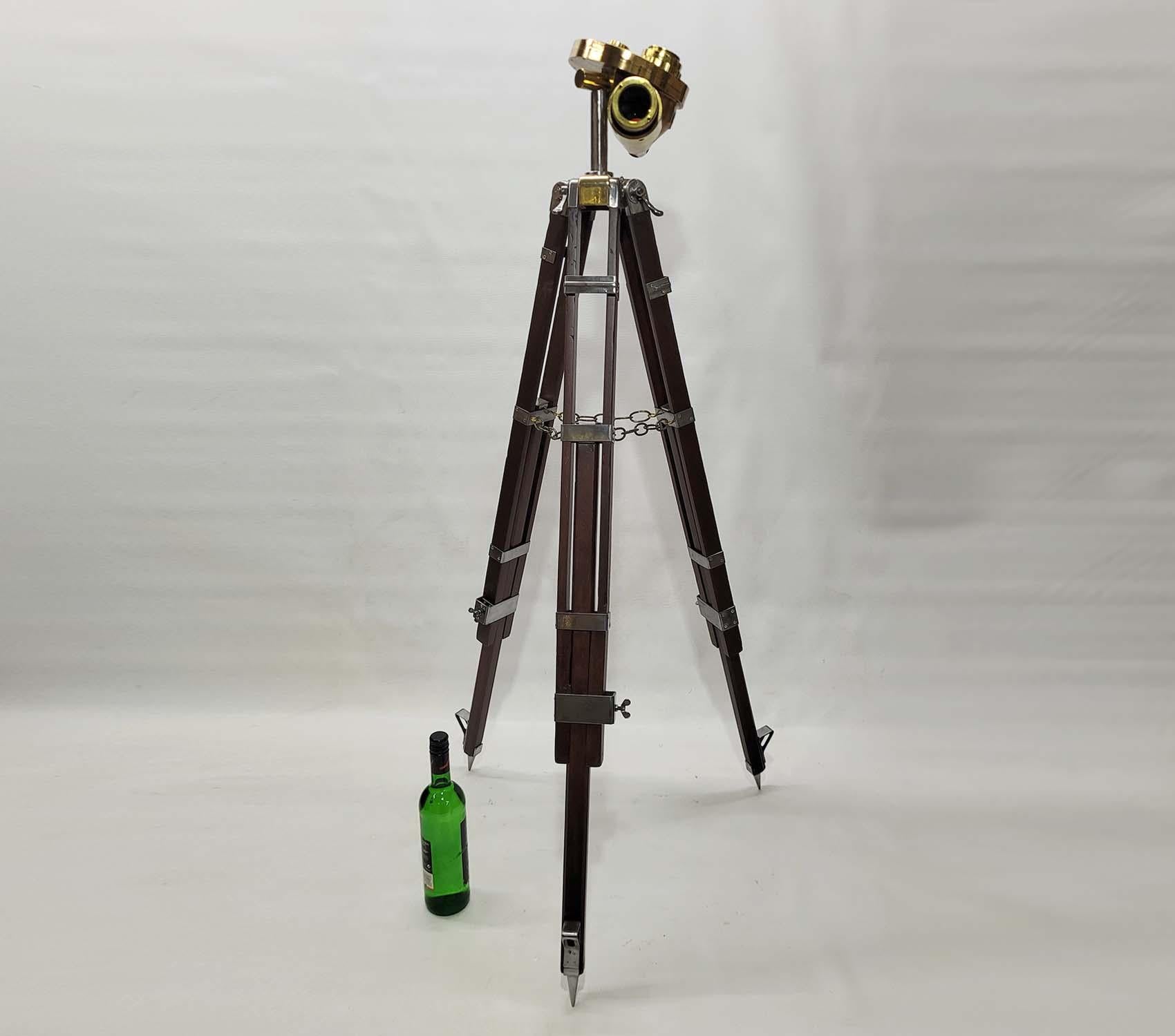 1943 United States Navy Telescope. Used primarily as part of the Mark 16 Aiming System on 50 caliber anti-aircraft gun mounts. Fitted with three sun filters and density knob. The instrument has been retro-fitted to an antique surveyor’s tripod.